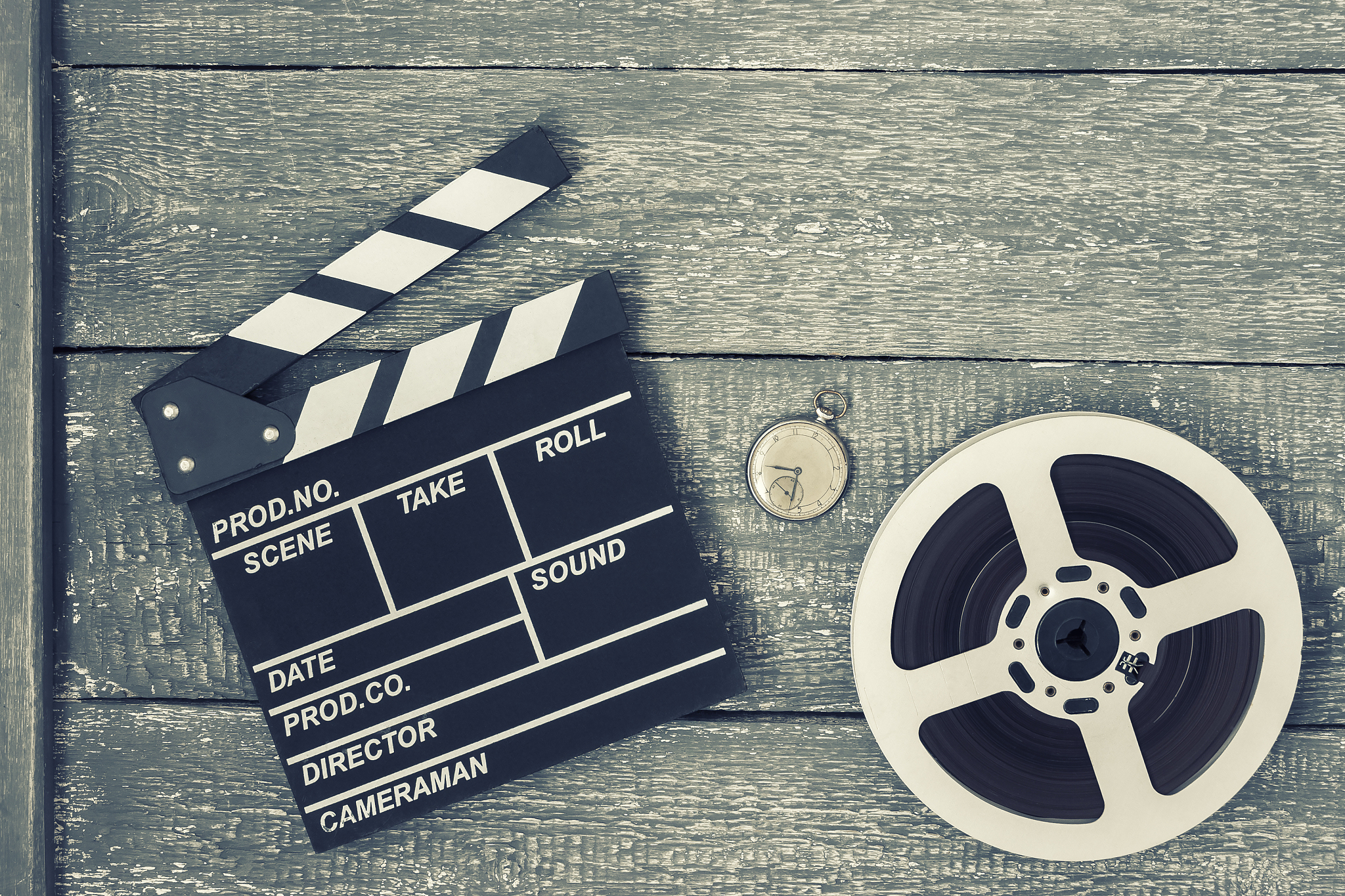 clapperboard, movie reel and pocket watch