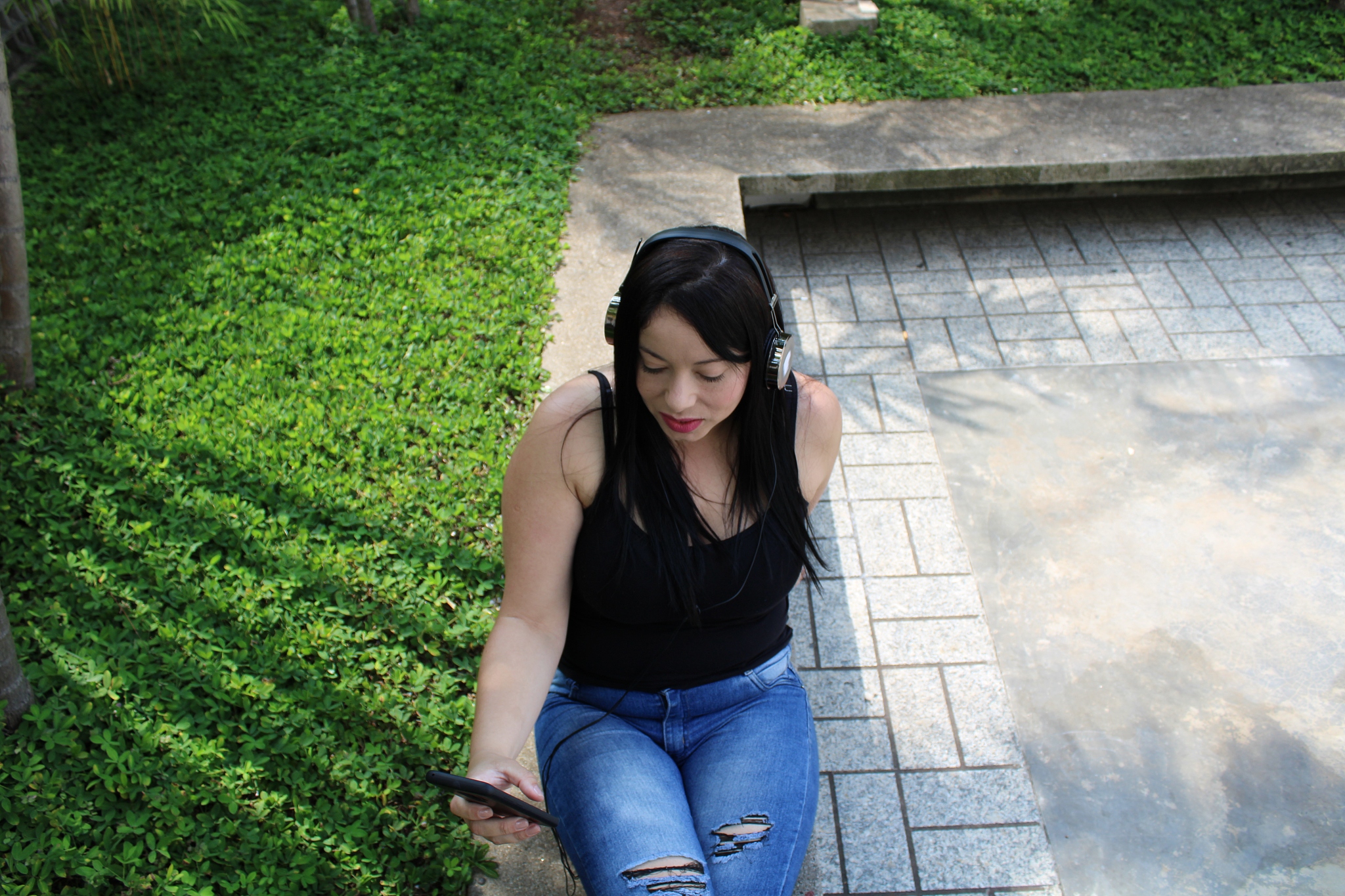 woman listening to music with cell phone and earphone