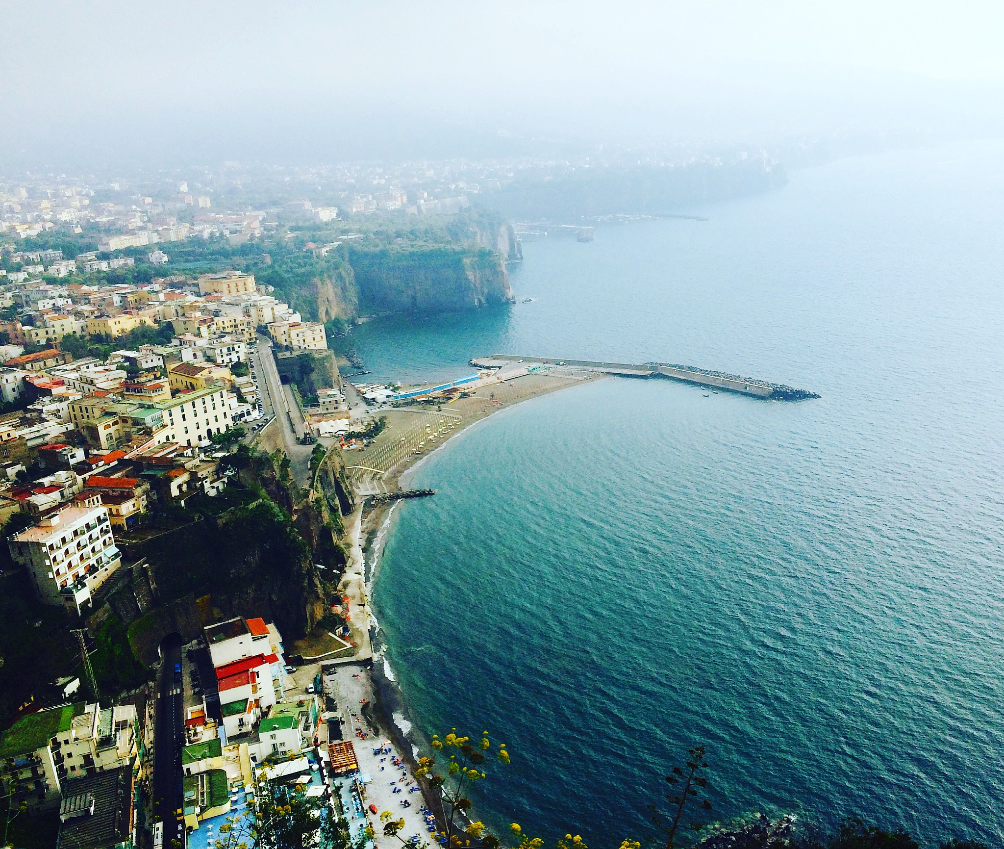 high angle view of cityscape by sea against sky