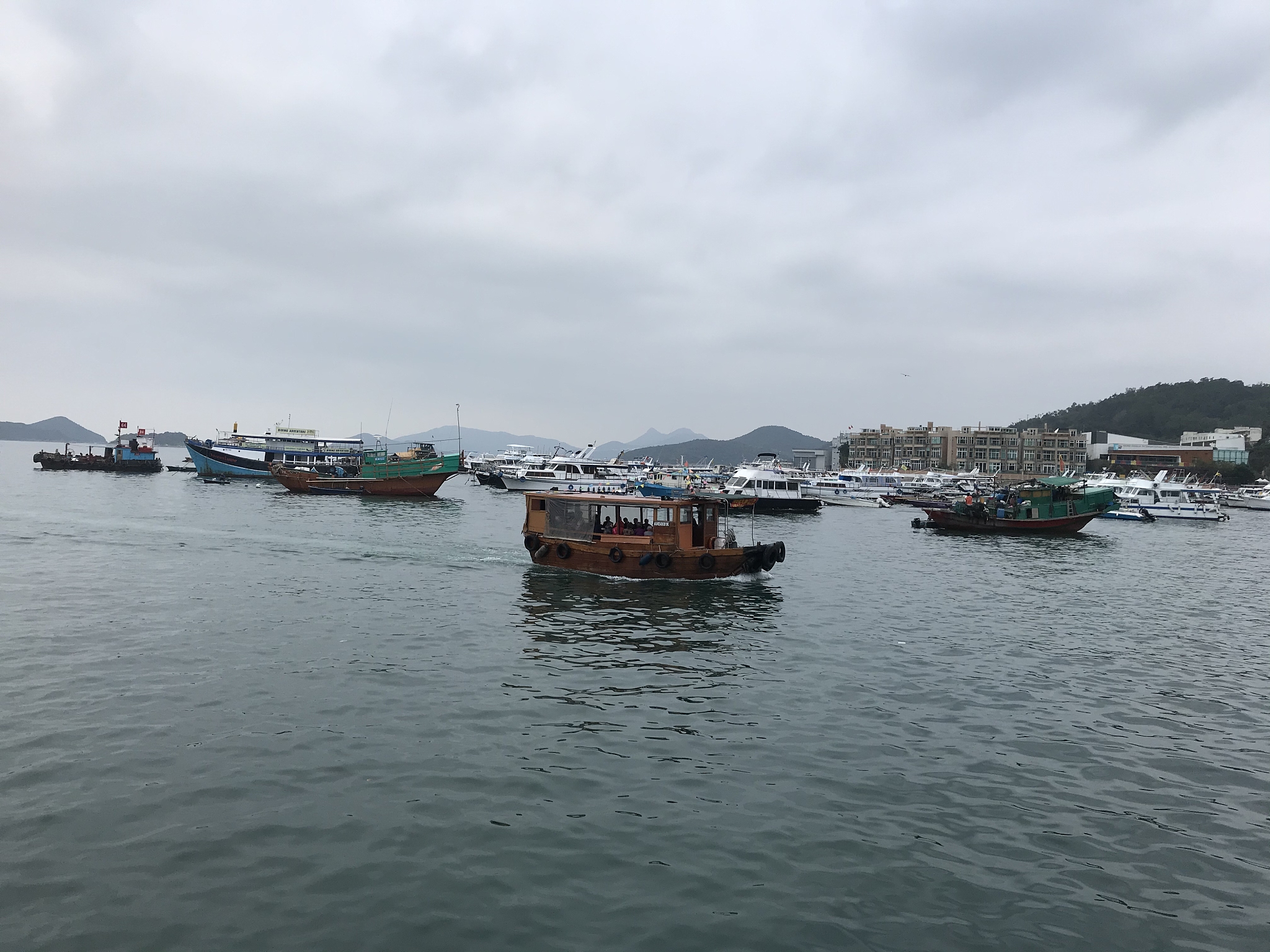 boats moored in sea against sky