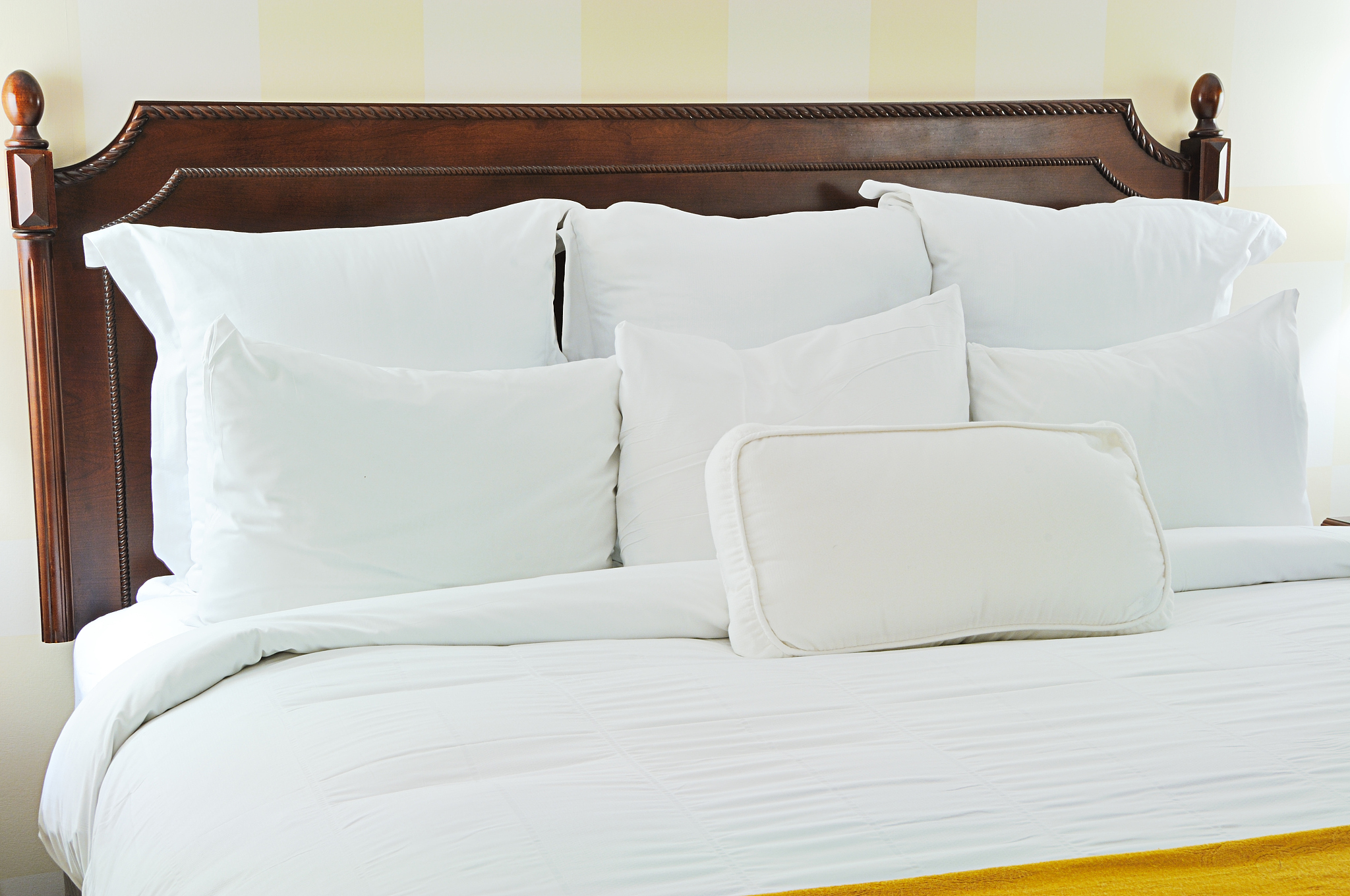 white linens and wooden headboard