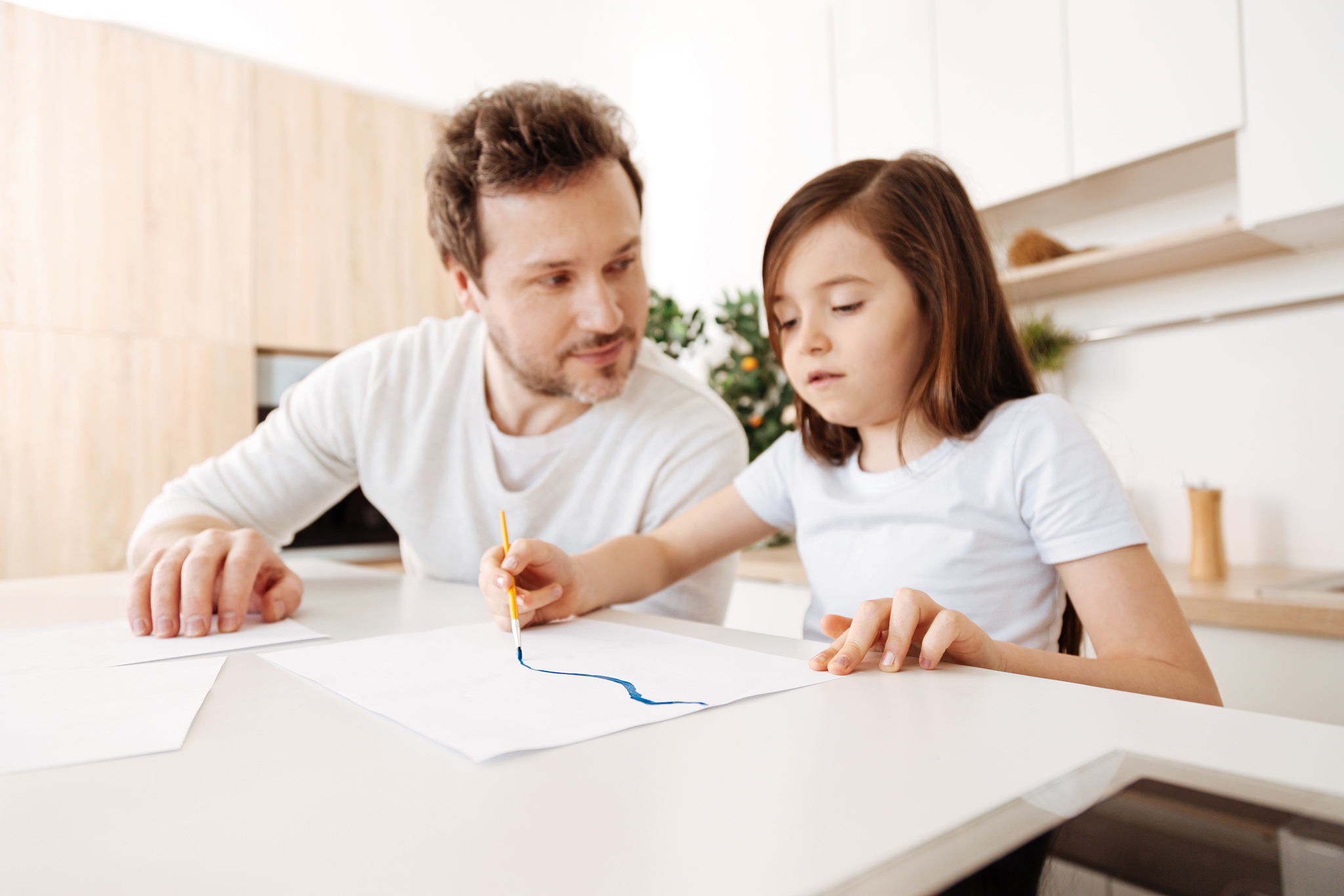 cute little girl painting a blue line