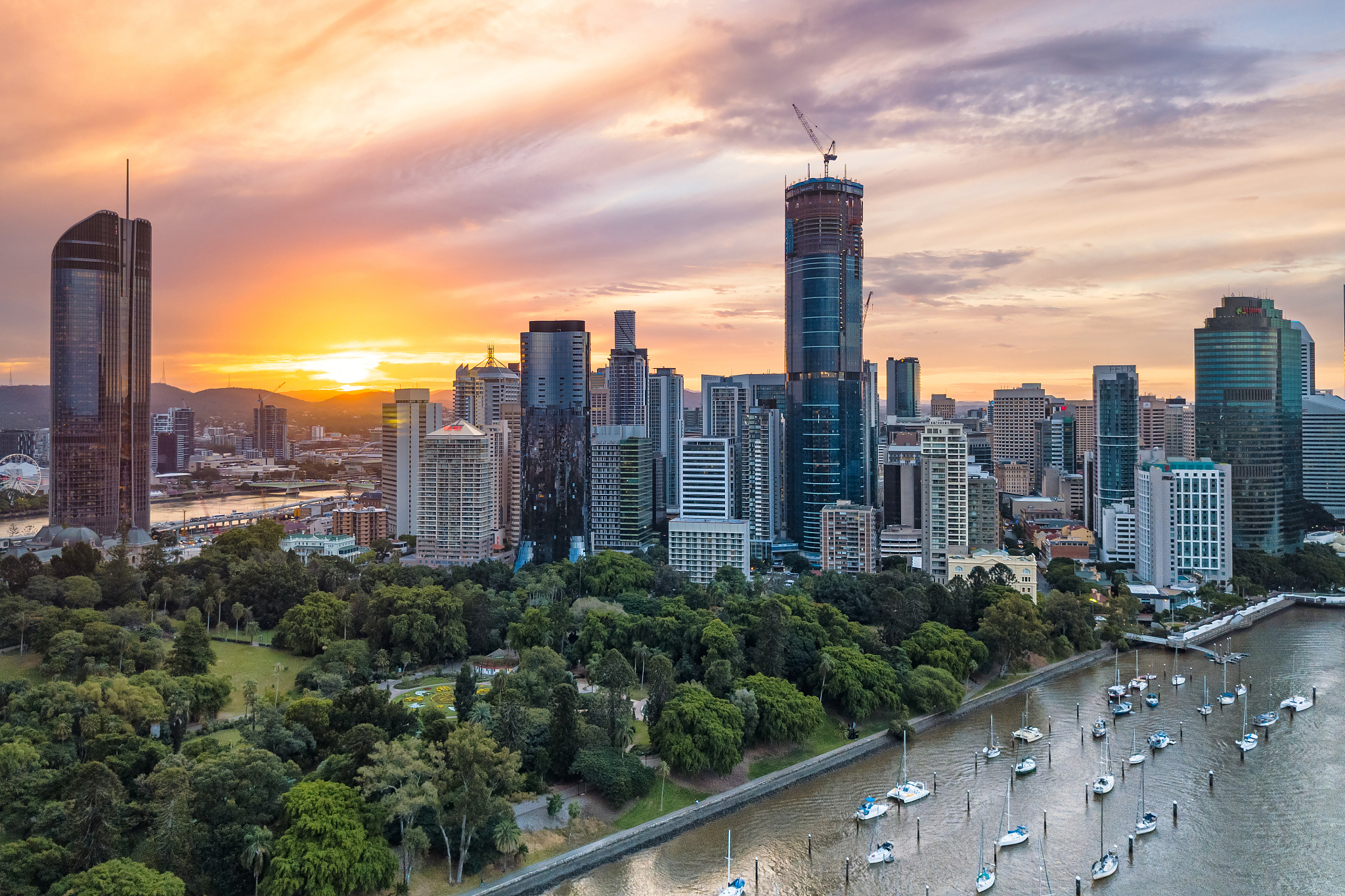 modern buildings in city against sky during sunset