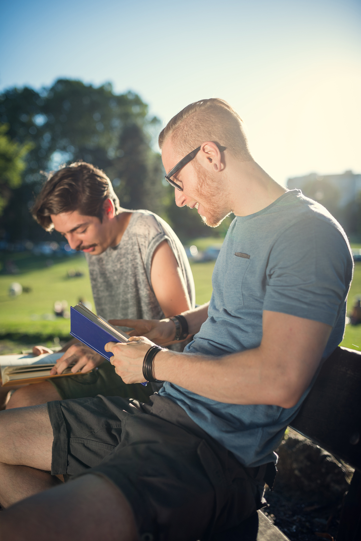 guys reading at the park