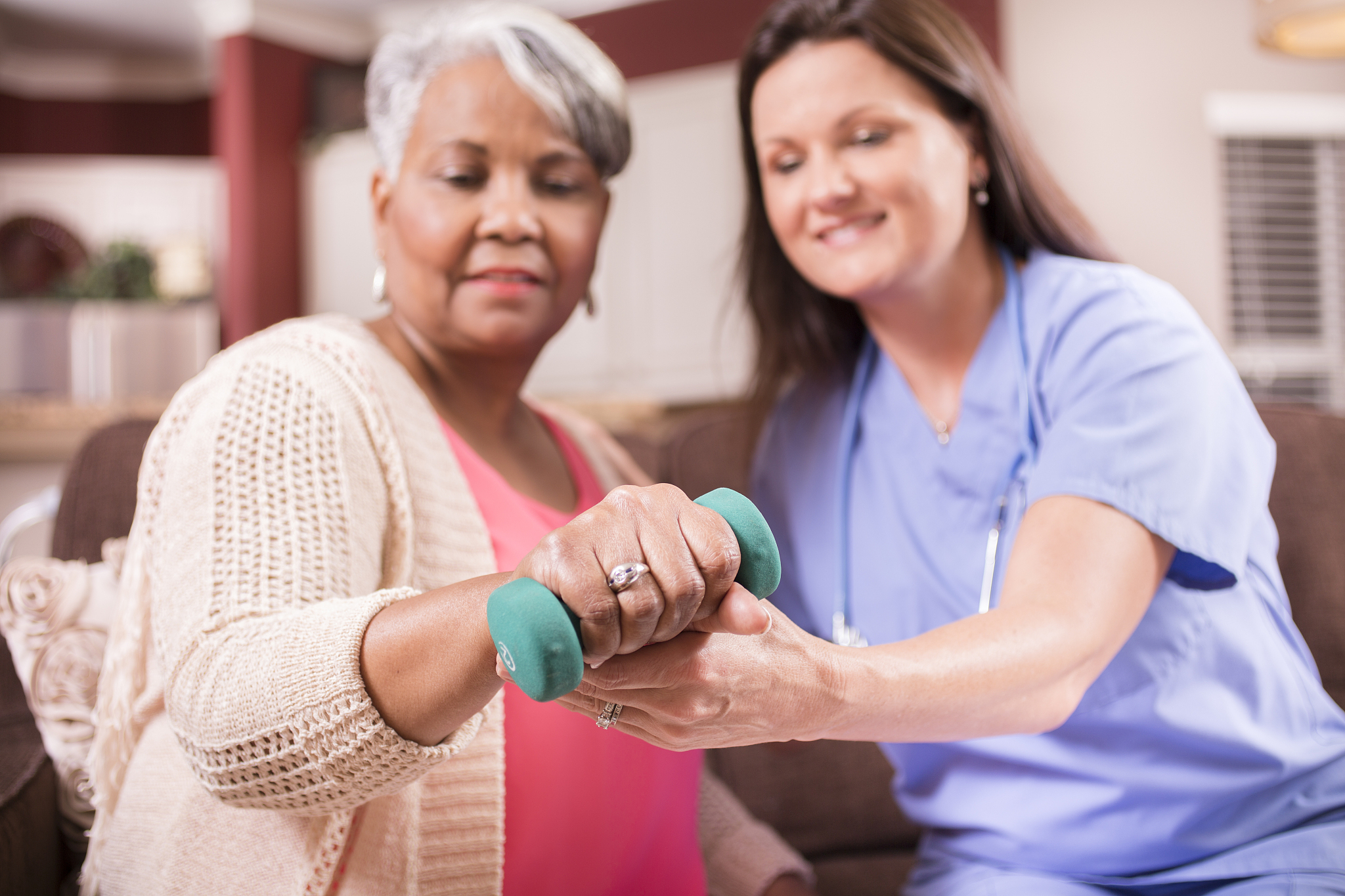 home healthcare nurse, physical therapy with senior adult woman.