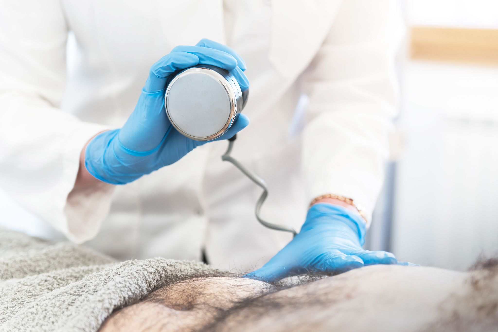 man on ultrasound lipolysis treatment at clinic