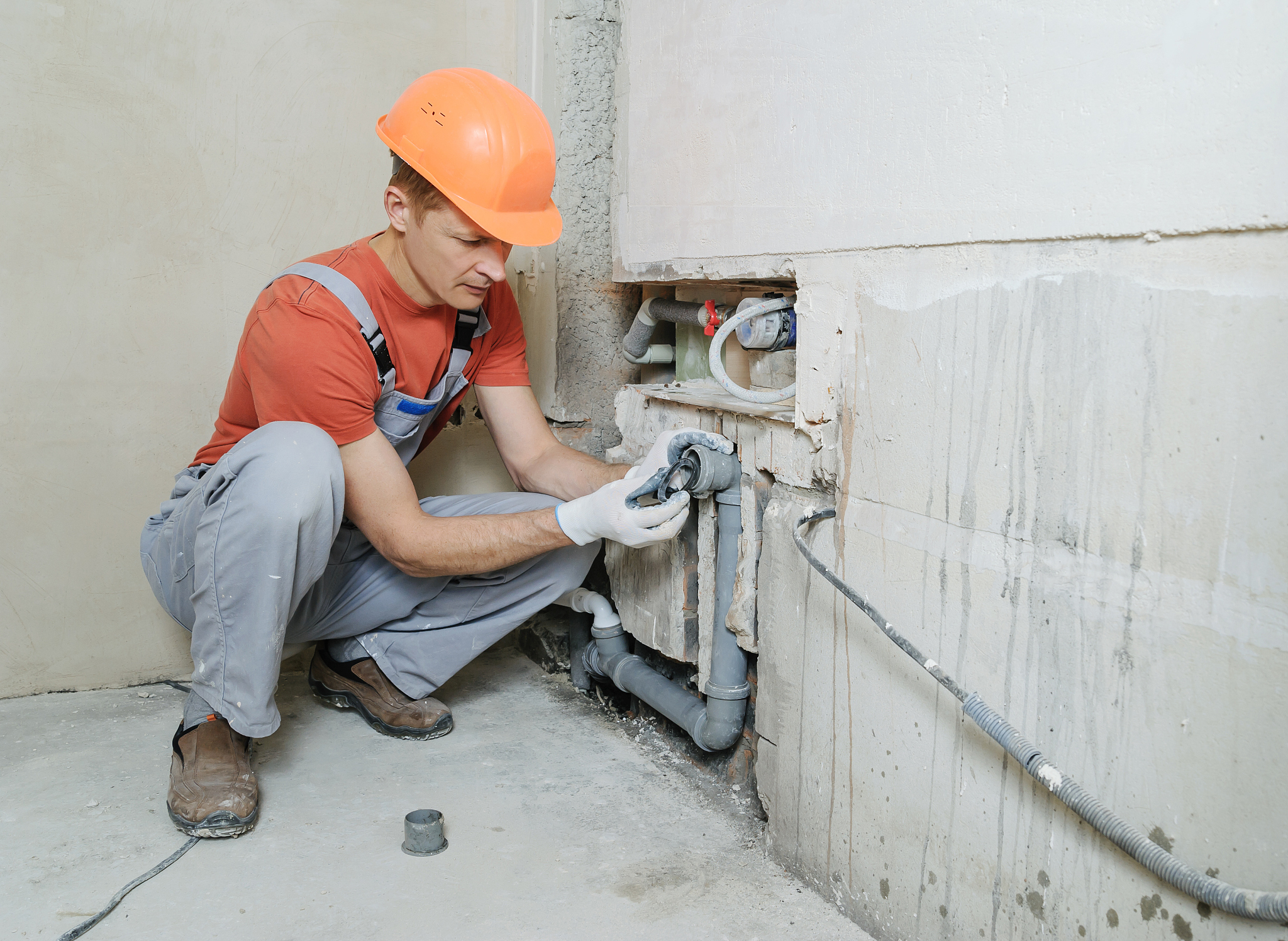 worker is installing sewer pipes.