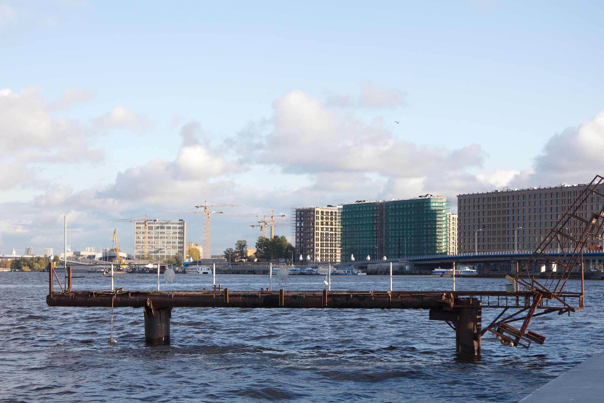 jetty on the river in the city on a sunny day