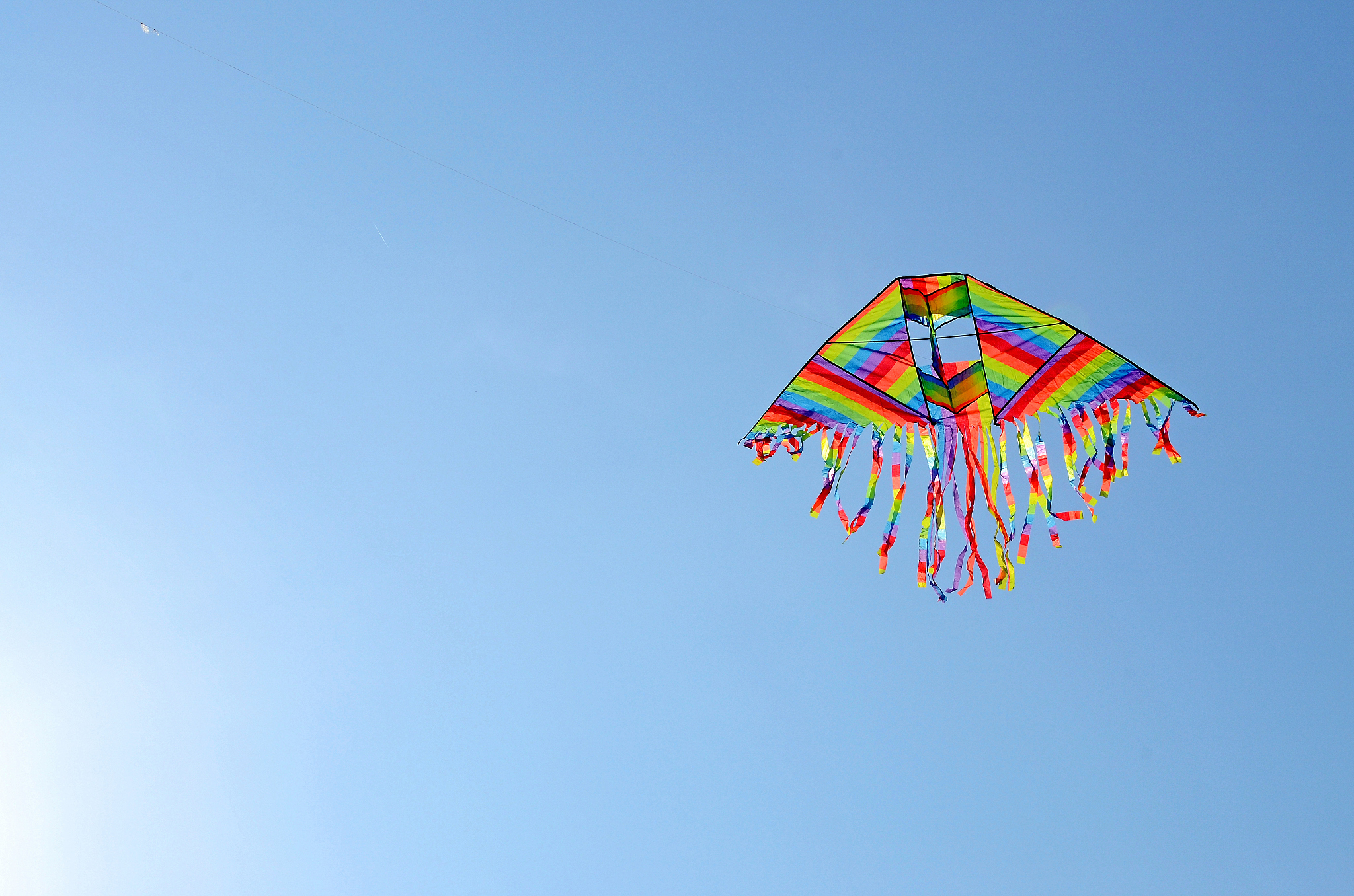 colourful kite flying in clear blue sky, india