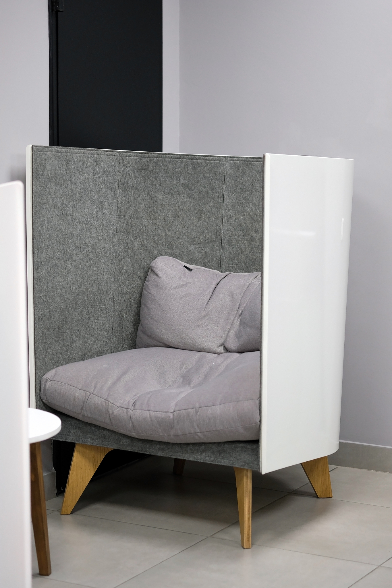 gray armchair on wooden legs.