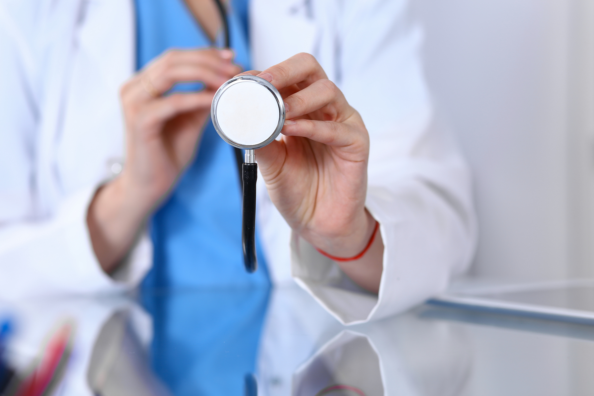 doctor holds stethoscope head, close-up. medical help and insura
