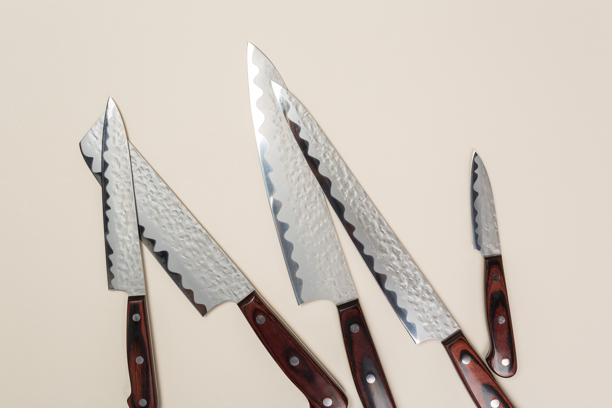 a set of knives lies on a colored background. professional cook 