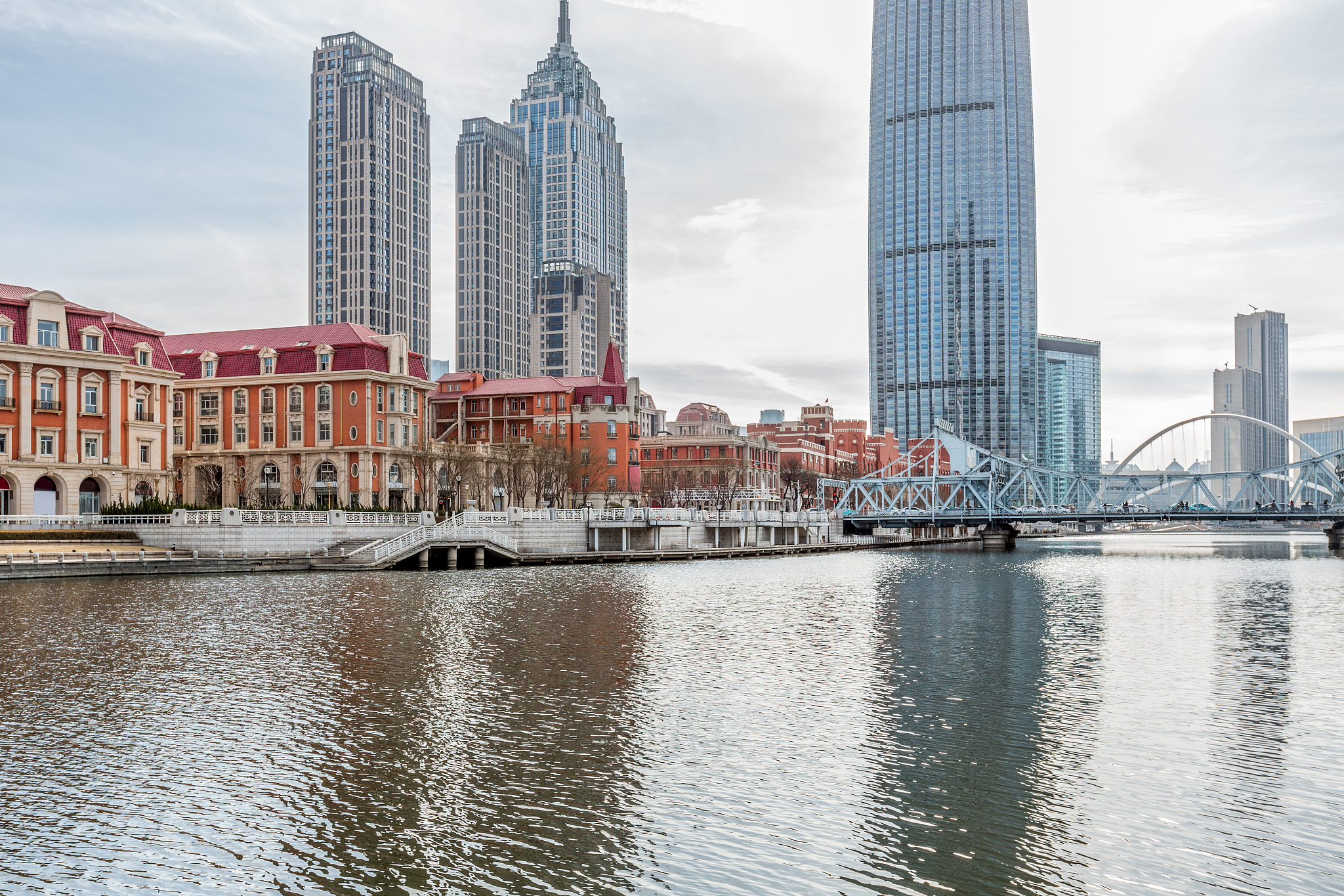 river and modern buildings against sky