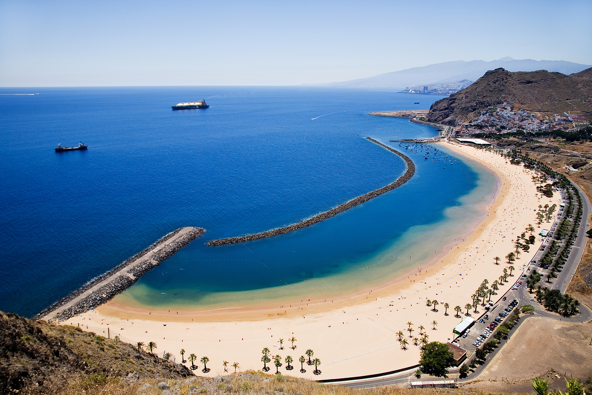 panoramic view of the coastline with beach and mountains