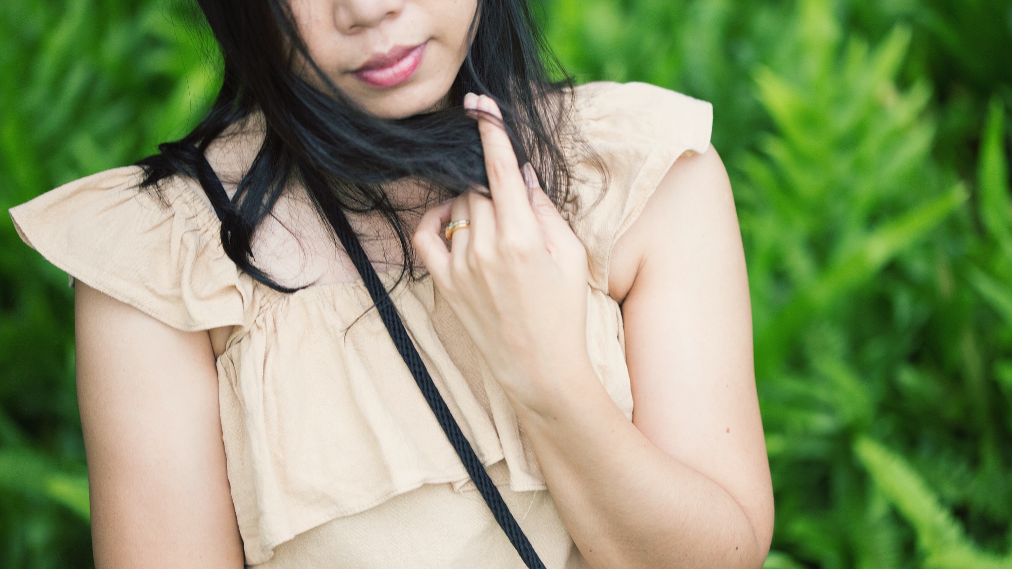 midsection of woman standing against plants