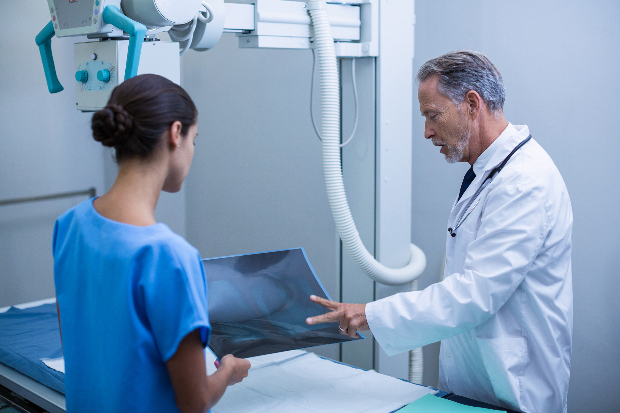 doctor and nurse discussing over x-ray