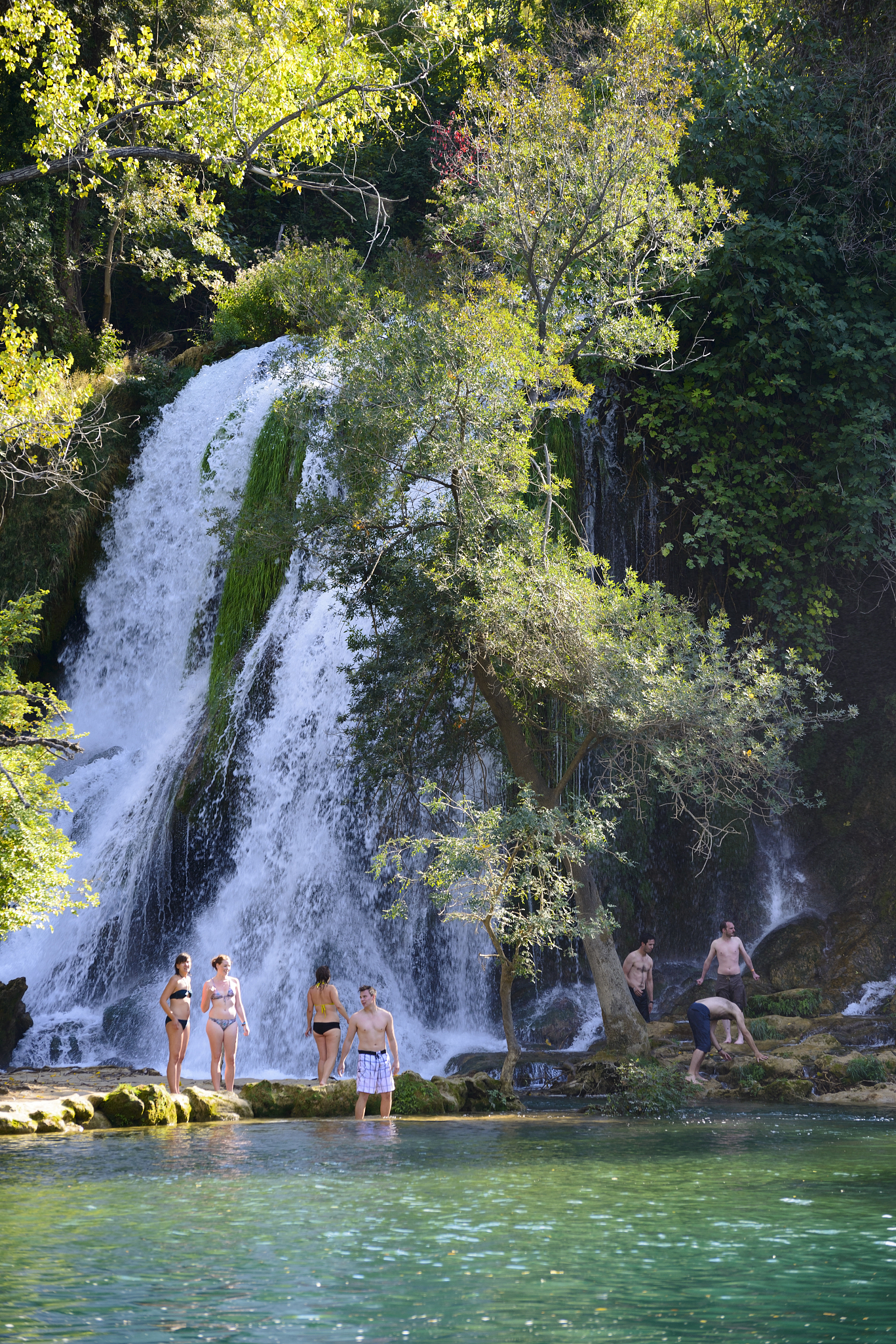 backpackers at kravice waterfalls in bosnia