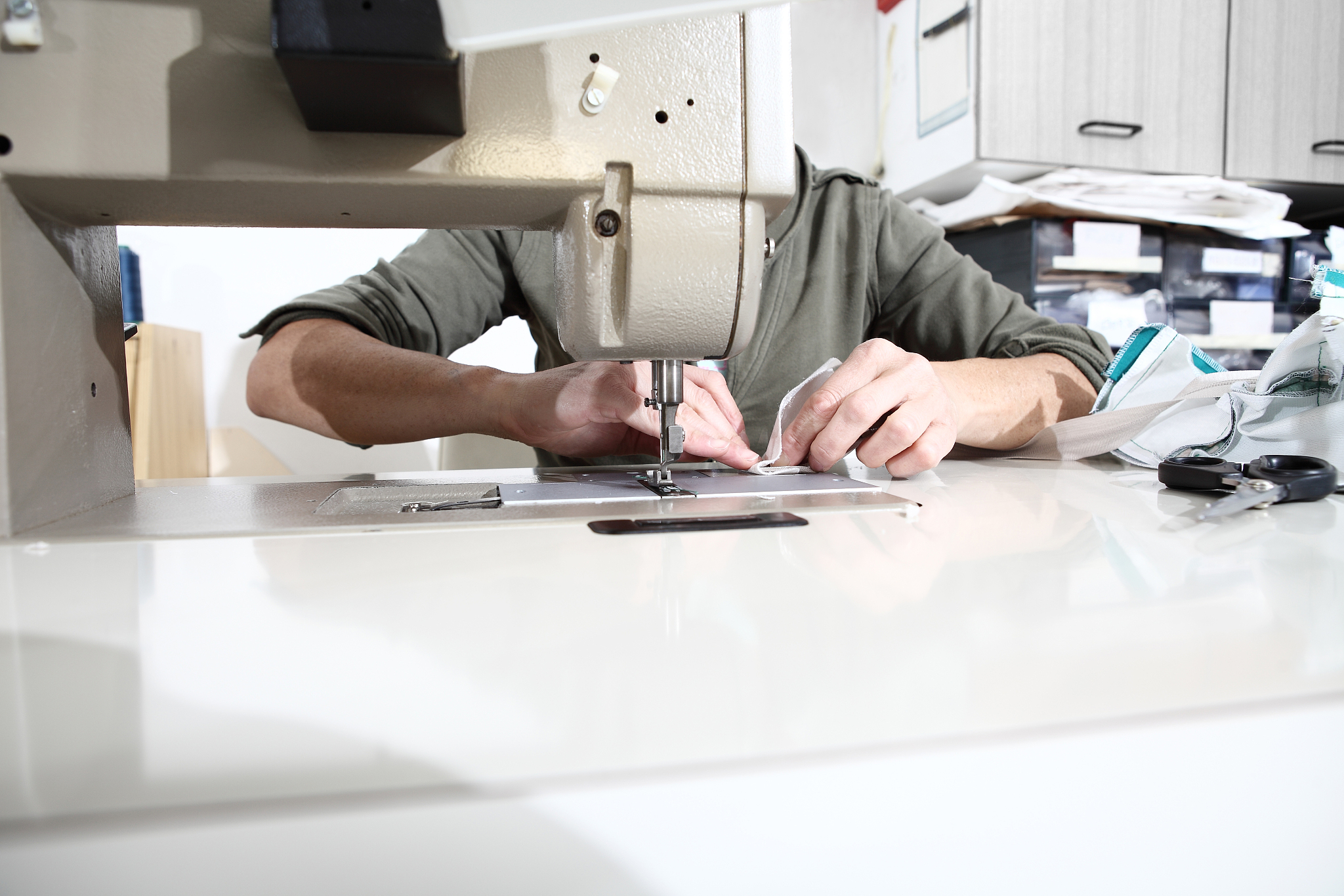 woman hands sewing machine, close up