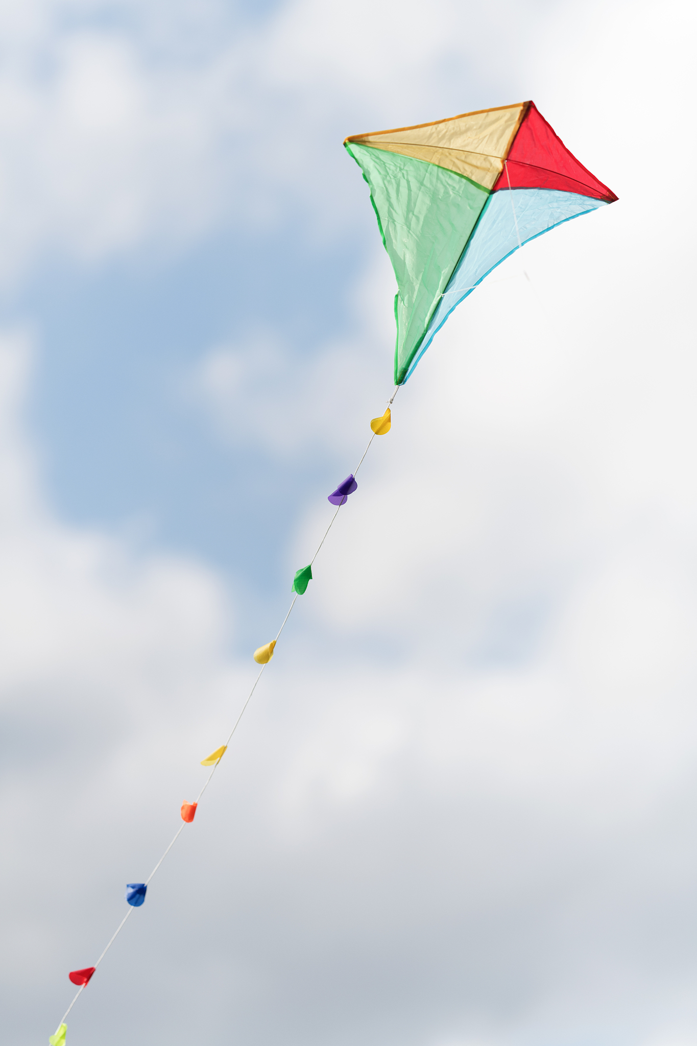 colorful kite in a cloudy sky