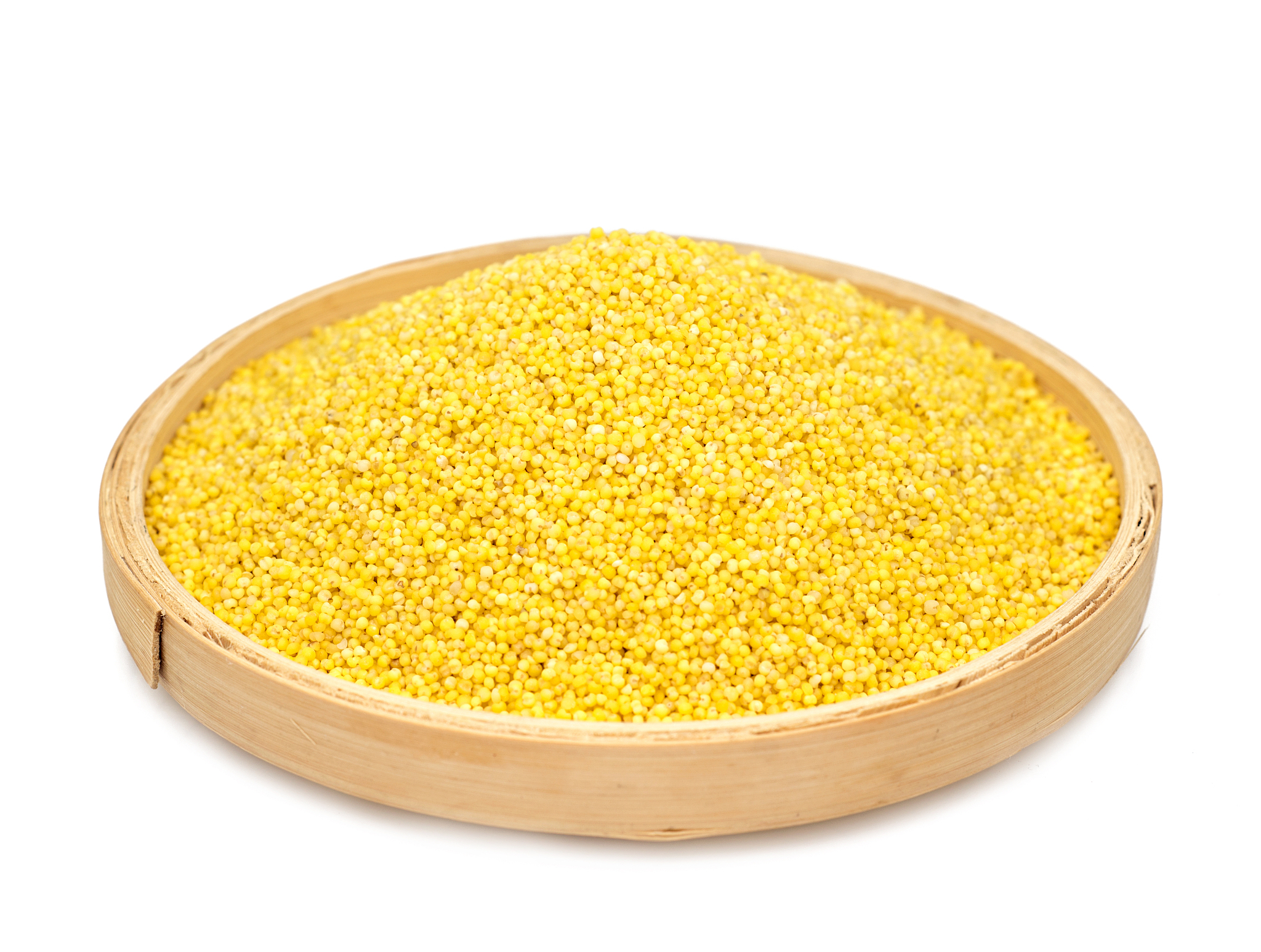 dry millet in white ceramic bowl isolated on white.
