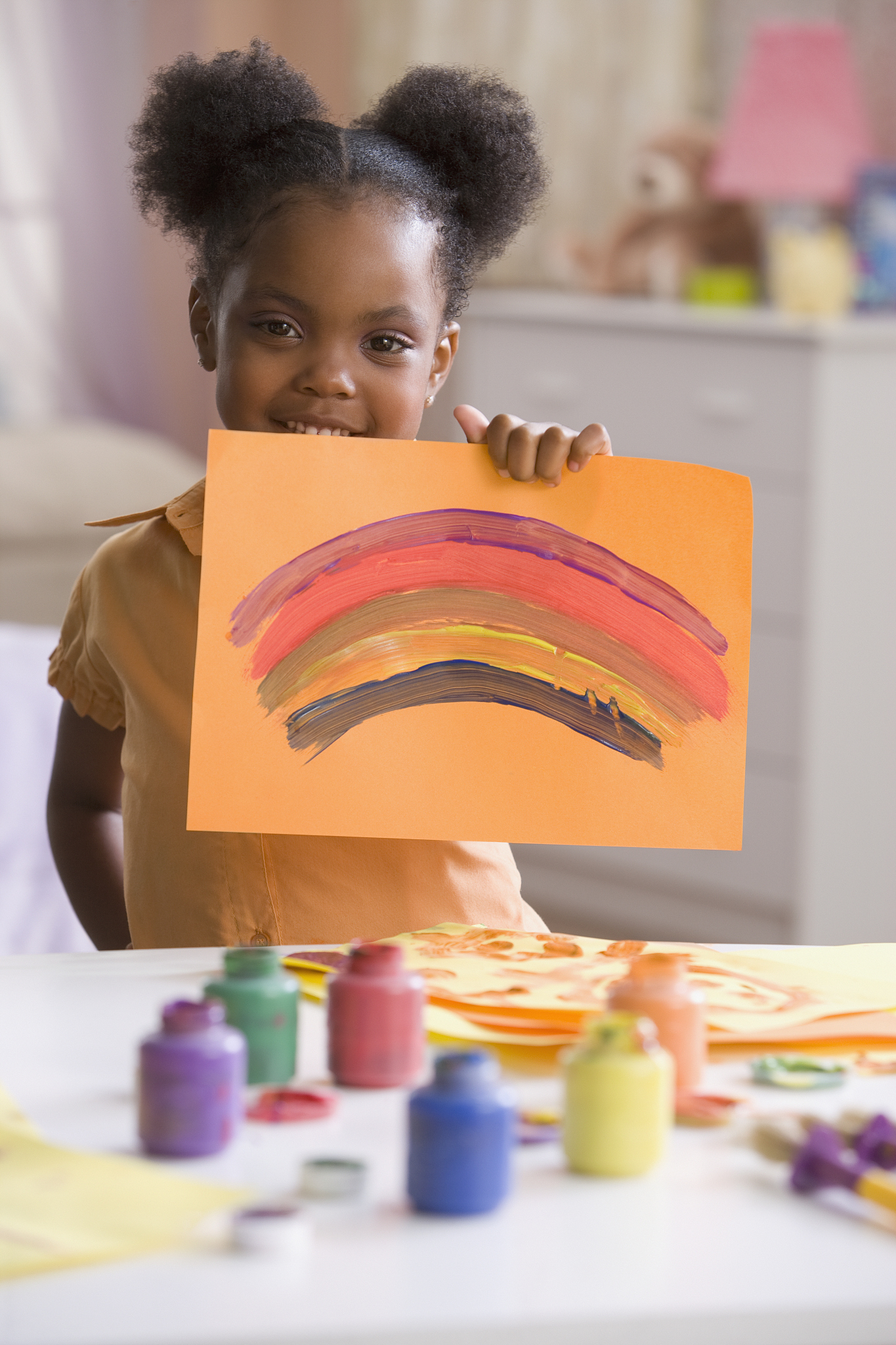 african american girl holding up painting