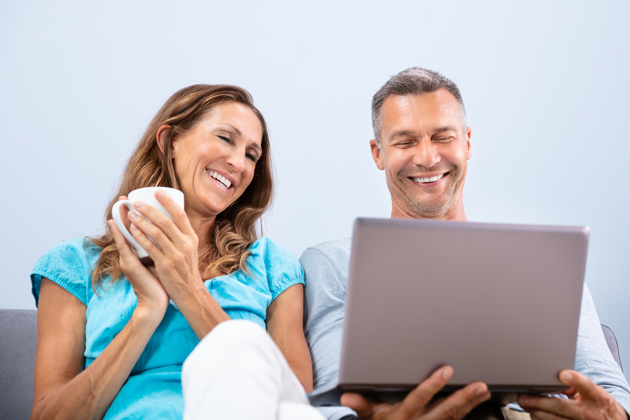 mature couple watching movie on laptop