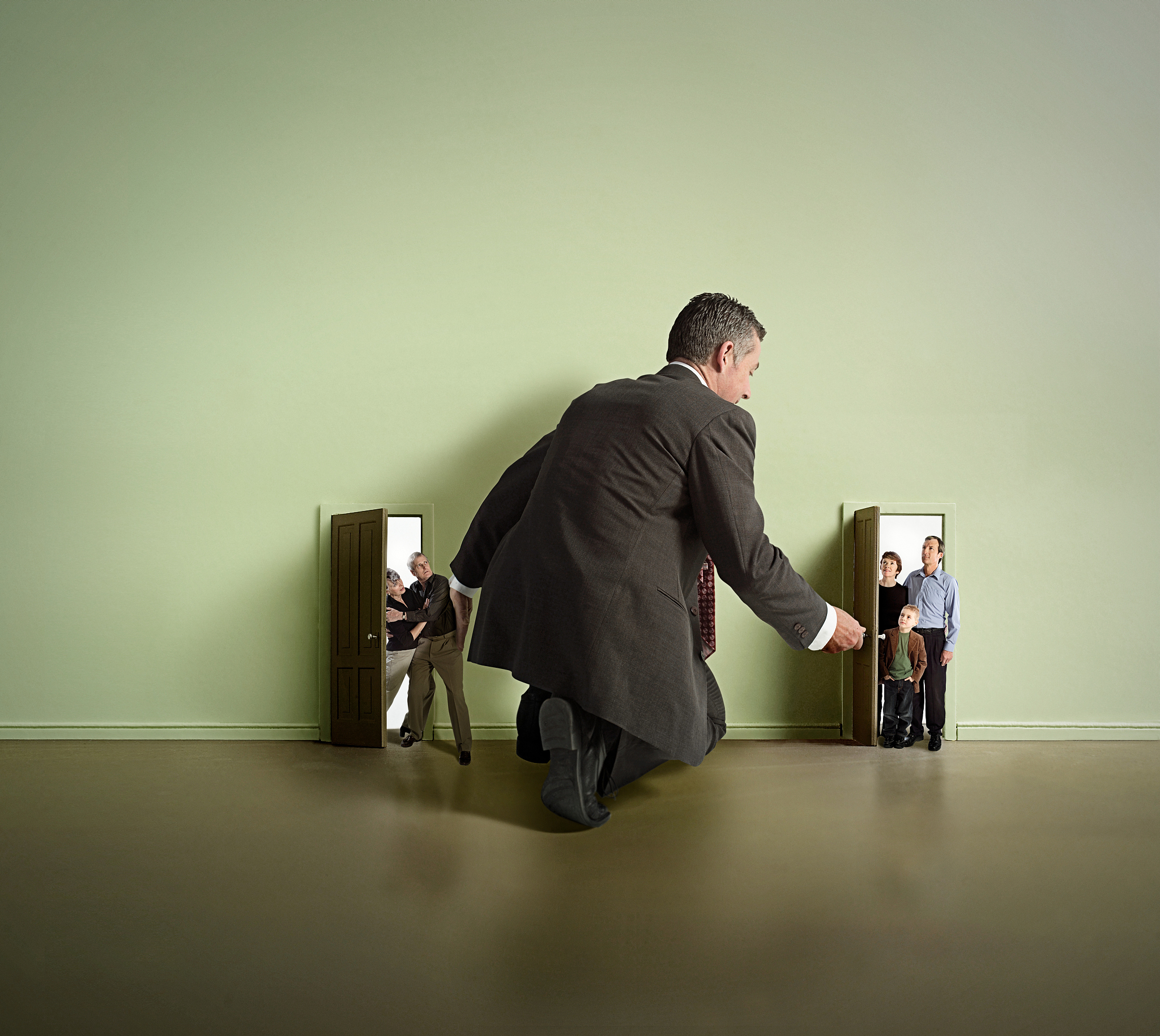man managing house guests in doorway