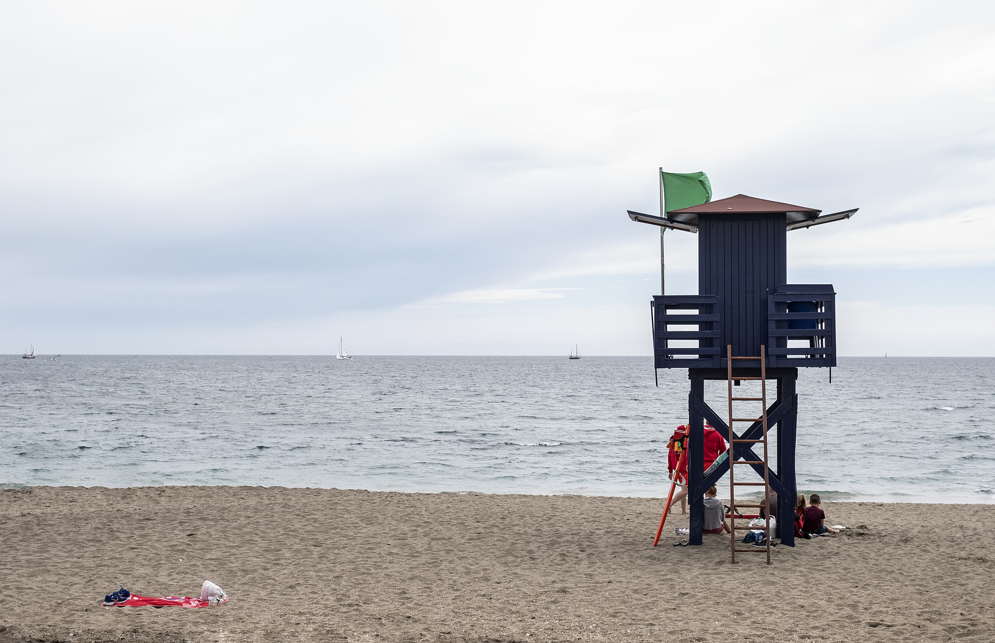 guard house with green flag of lifeguards on a spanish beach