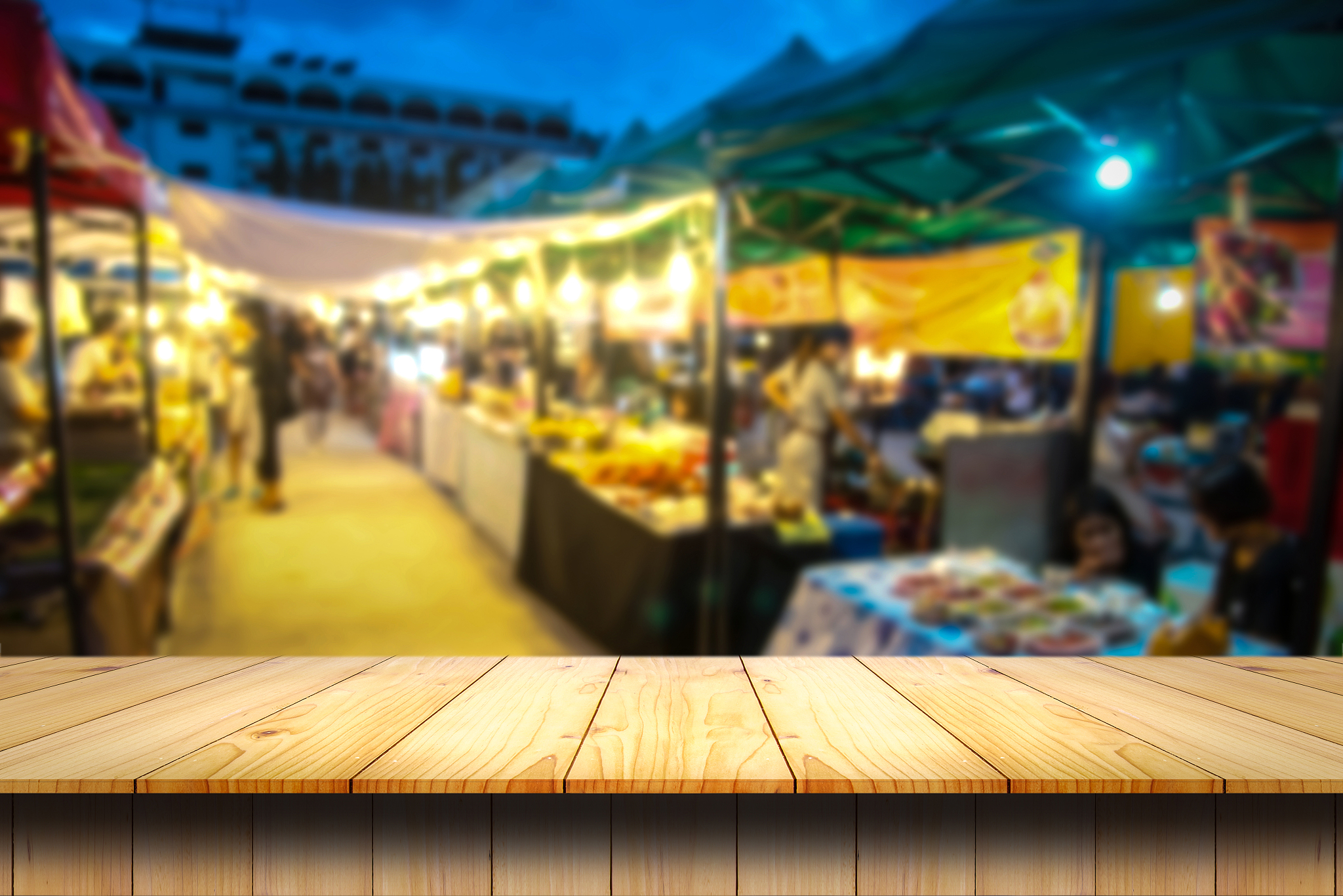 empty wooden table and blurred image of night market for product