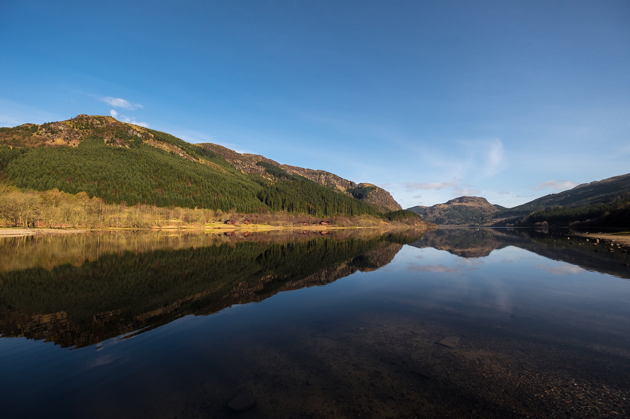 scenic view of lake and mountains against blue sky