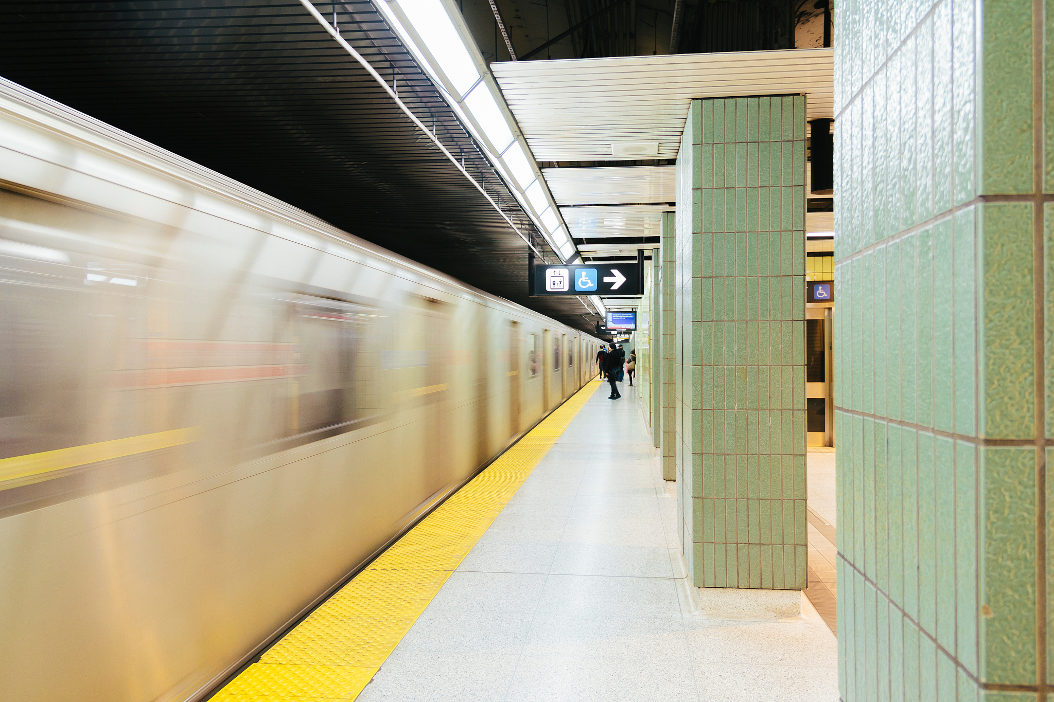 blurred motion of train at railroad station
