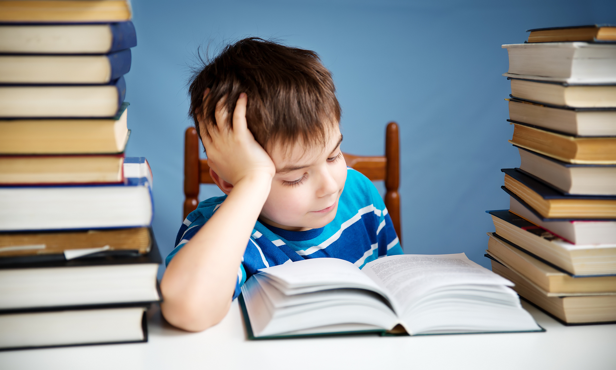 seven years old child reading a book