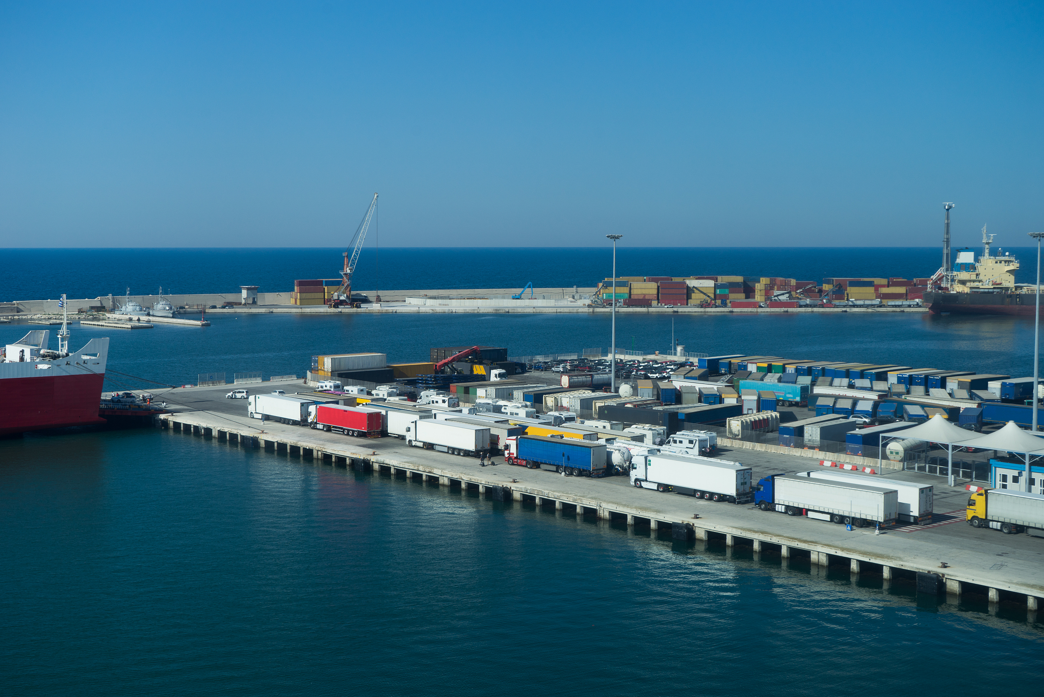 lorries and shipping containers inside a dock in italy