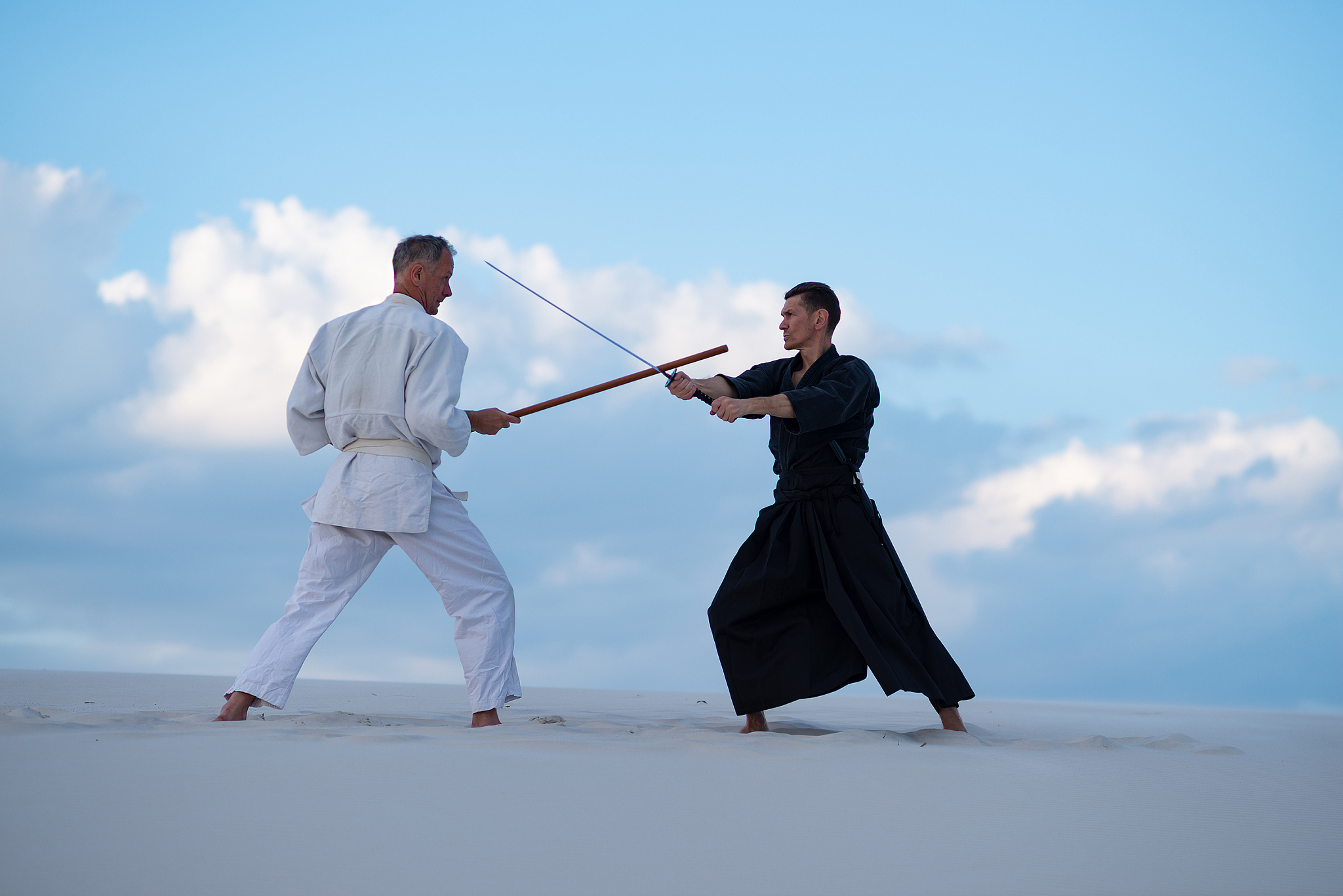 two resolute men, in japanese clothes, are practicing martial ar