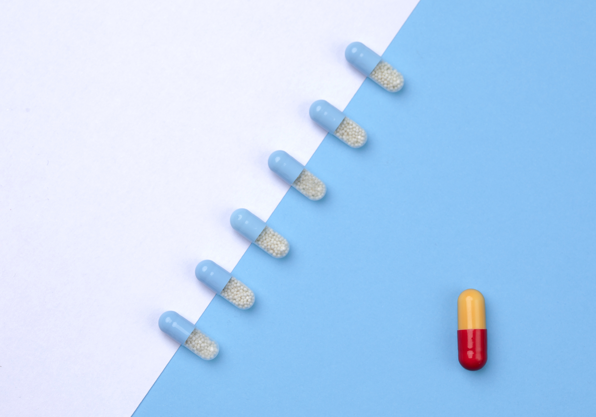 one red pill among white pills. concept of uniqueness