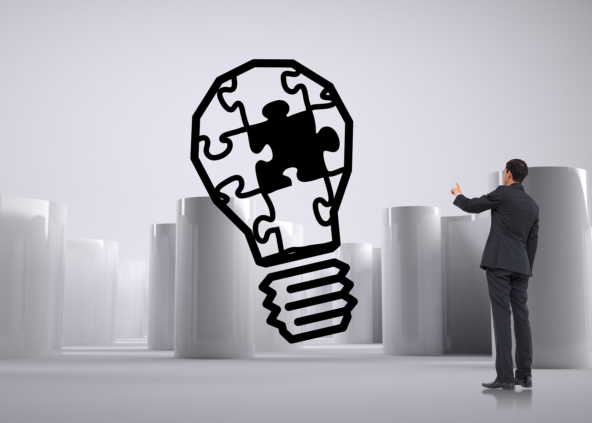 asian businessman pointing against light bulb graphic on futuris
