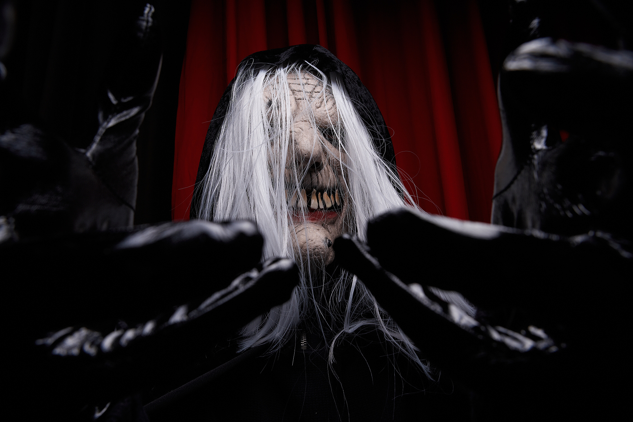 person in witch mask reaching out