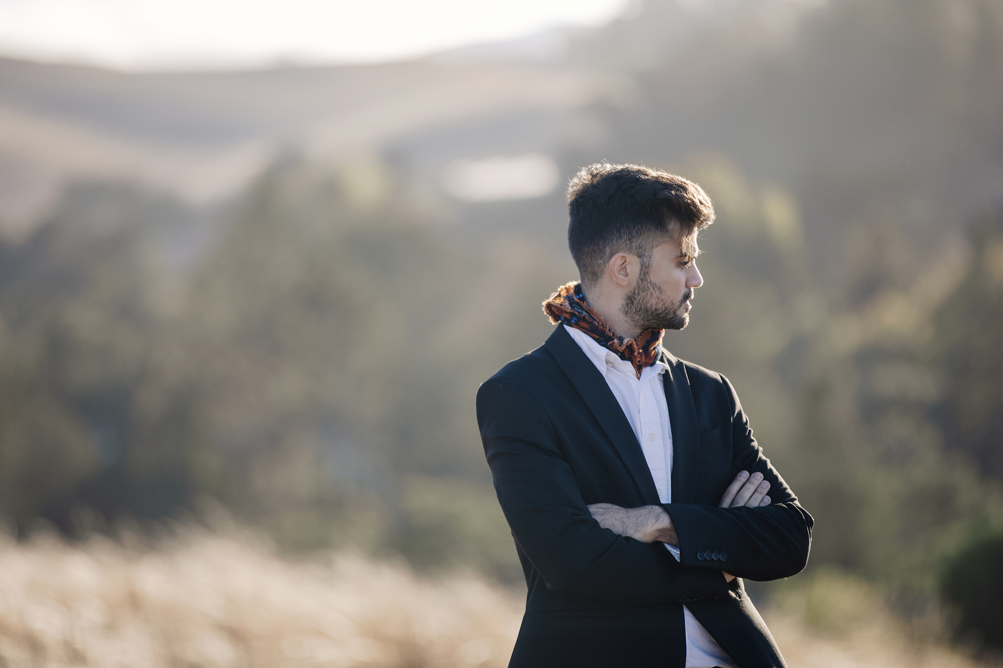 portrait of professional young man looking away by grass field
