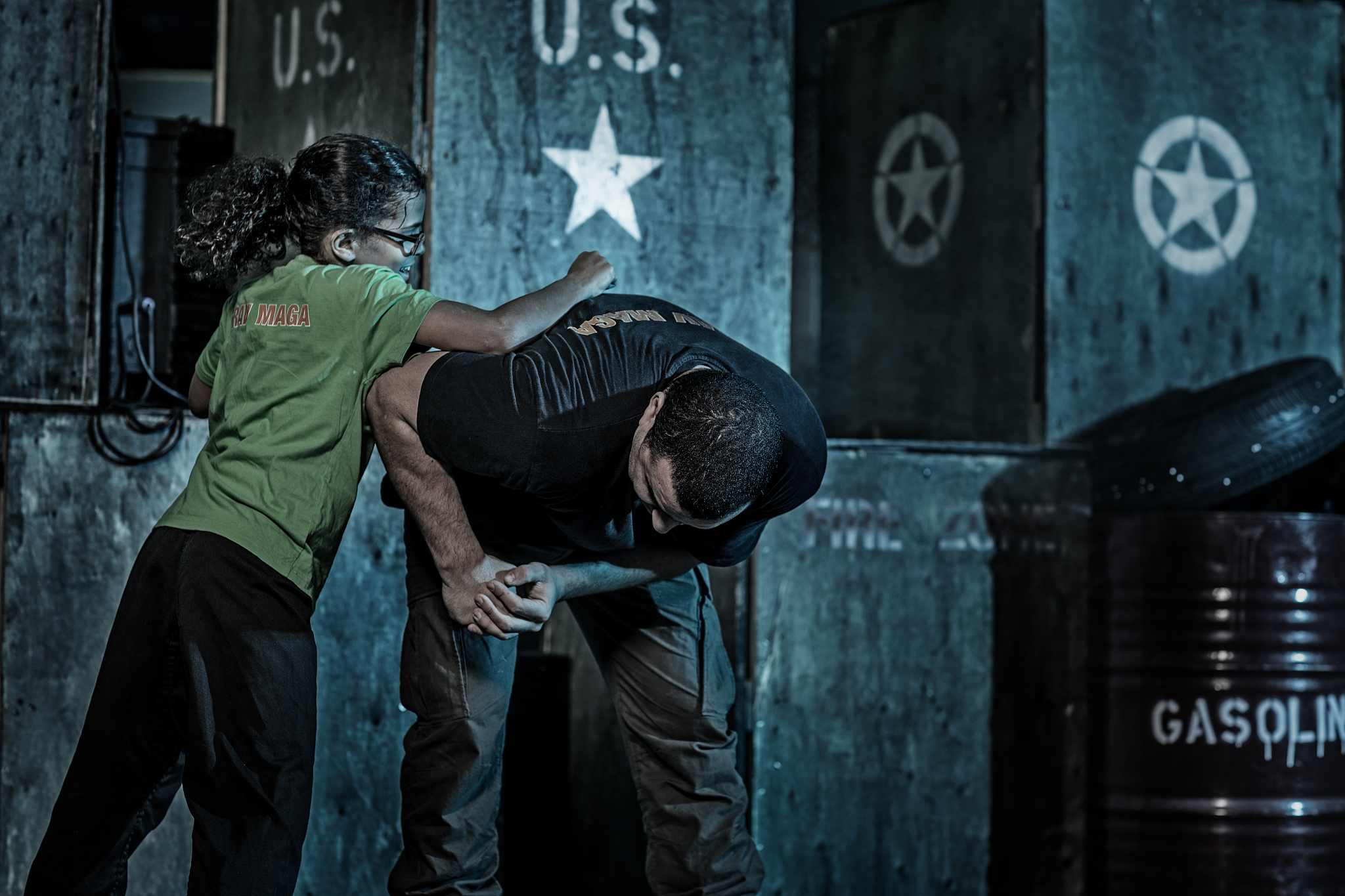 young girl using krav maga fighting self defense against male as