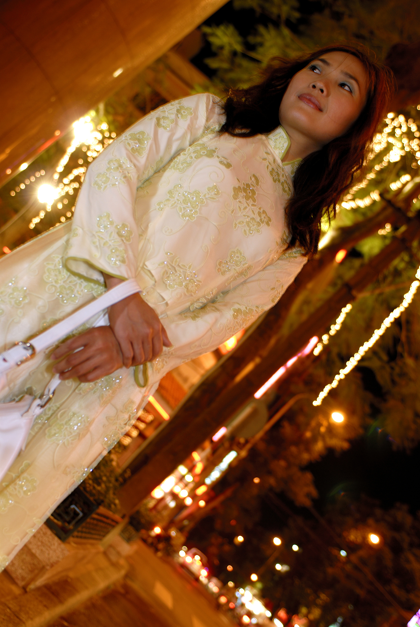 young woman standing on street, low angle view