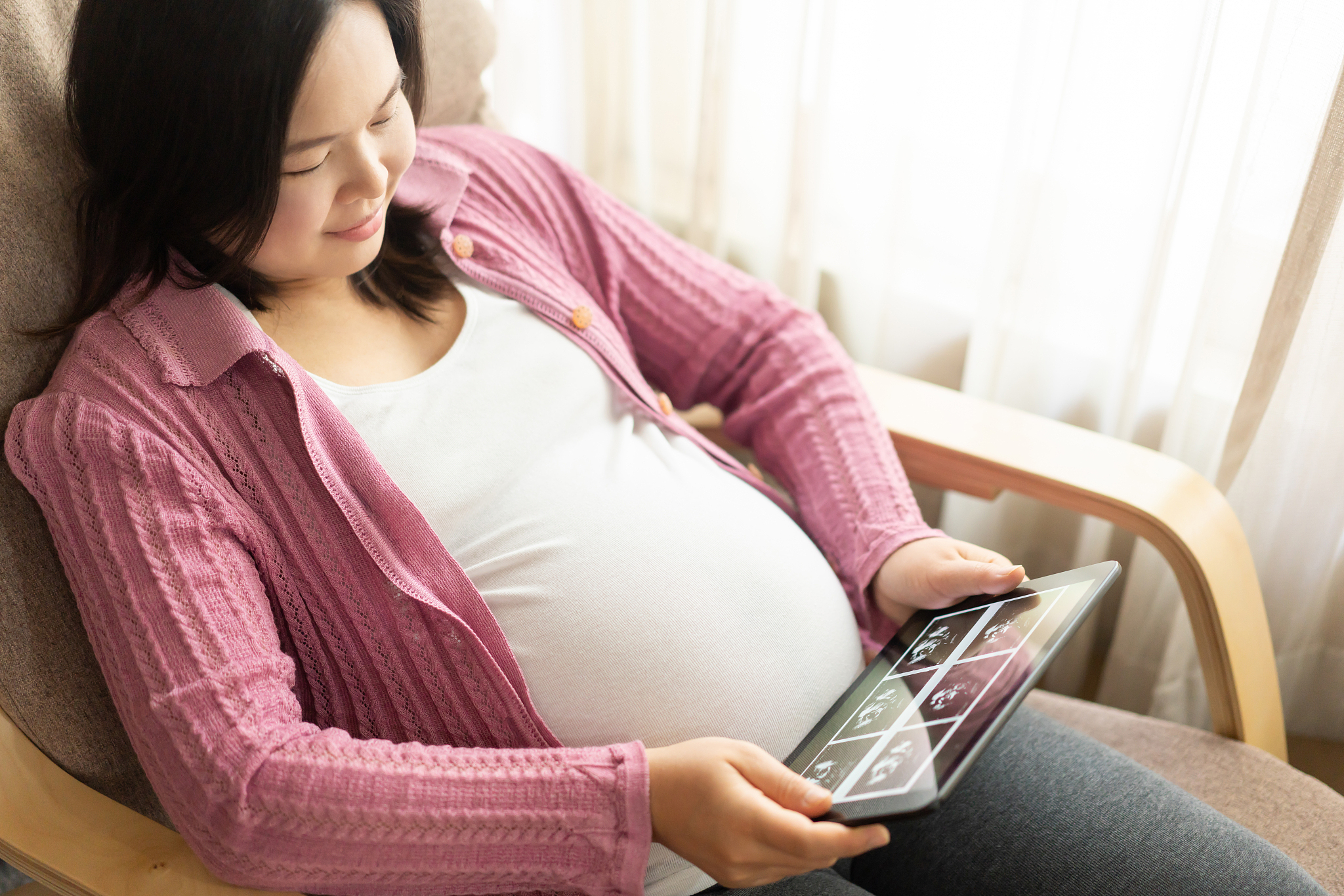 happy pregnant woman and expecting baby at home.