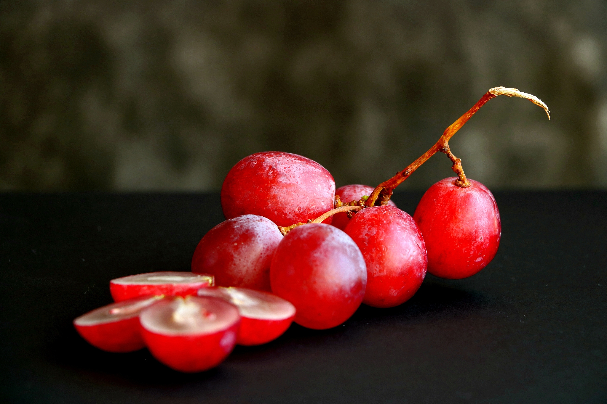 closeup of bunch of pink grapes.