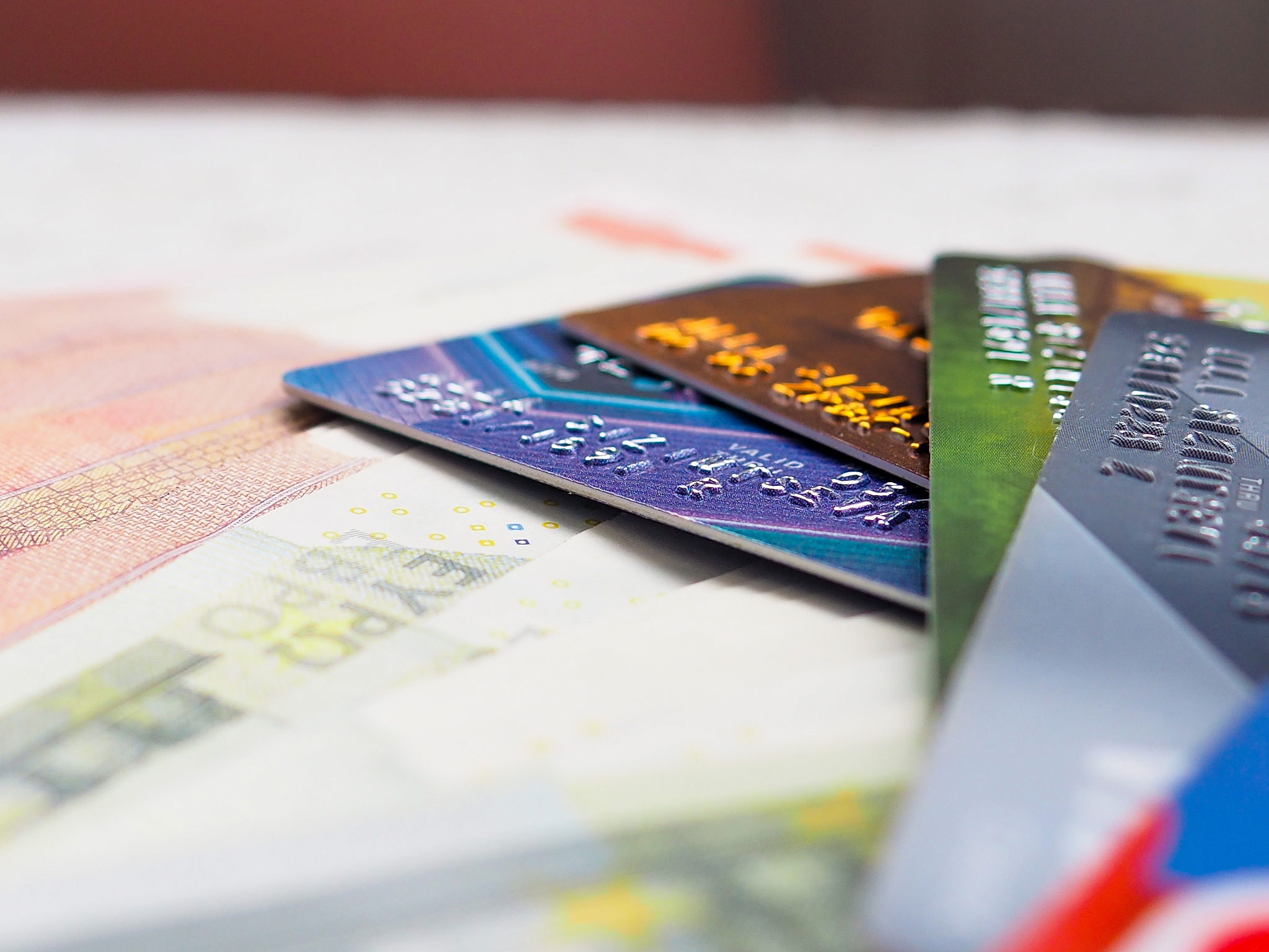 credit card and may euro bills as background