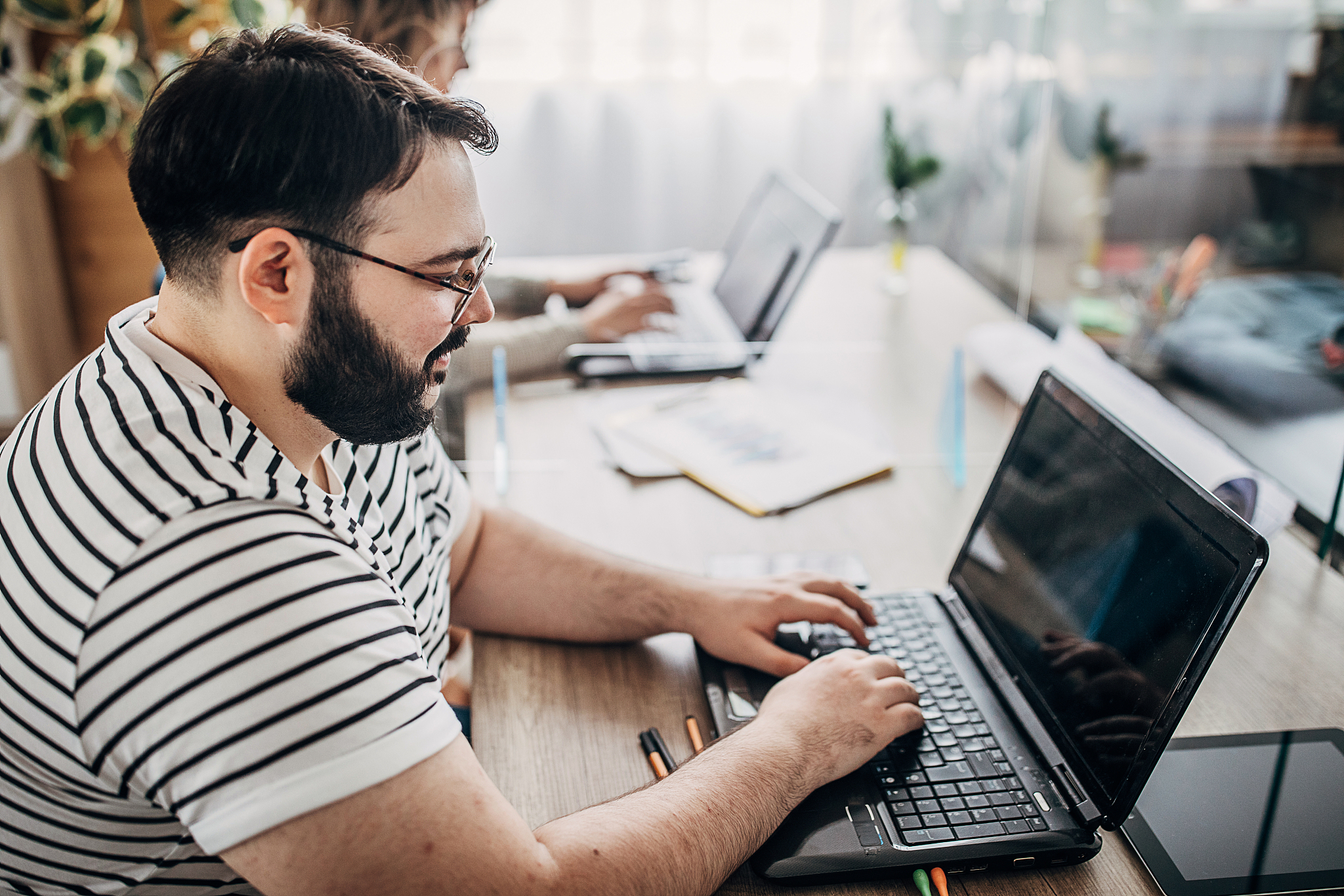 man and woman working in office