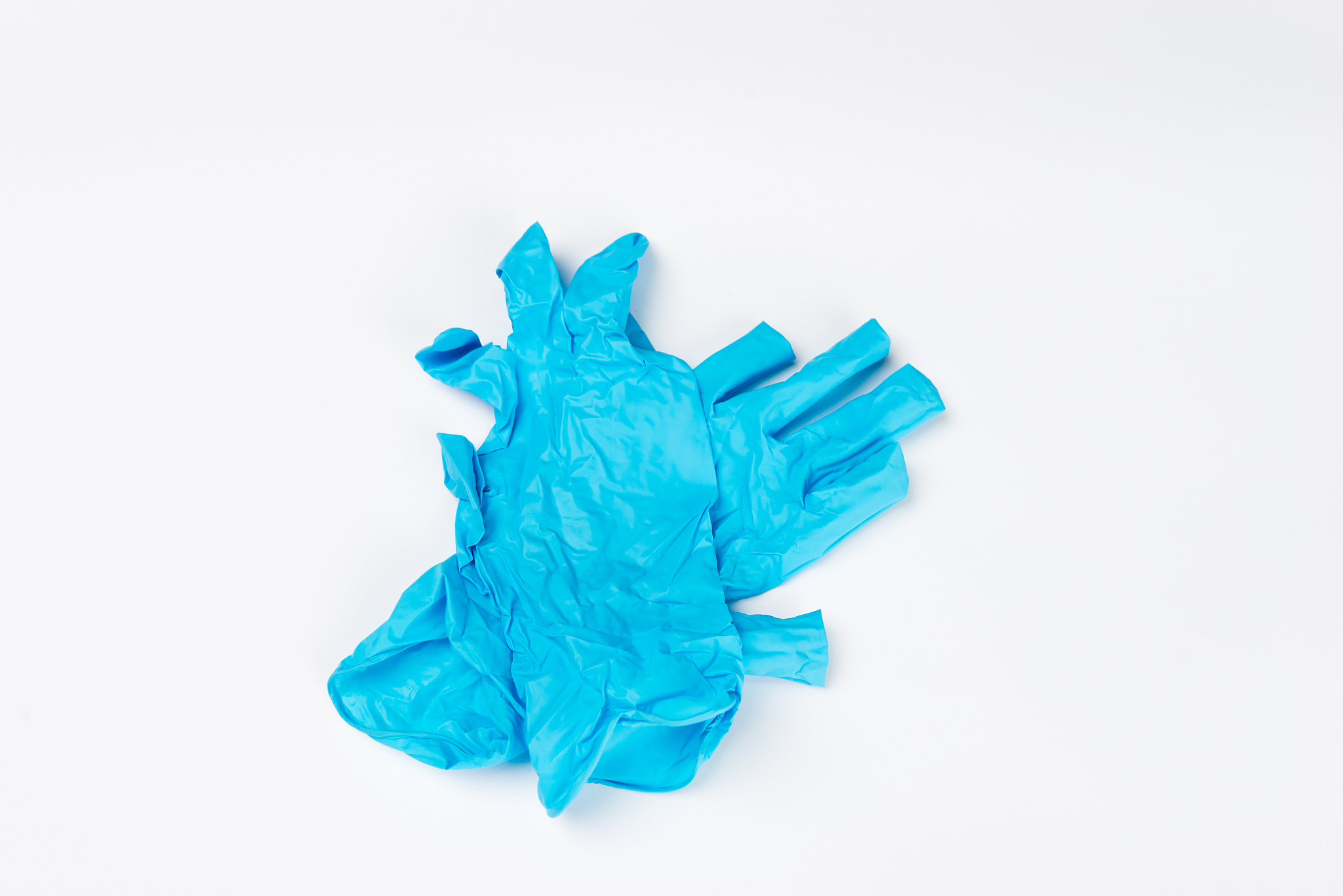 blue medical gloves after use on white background