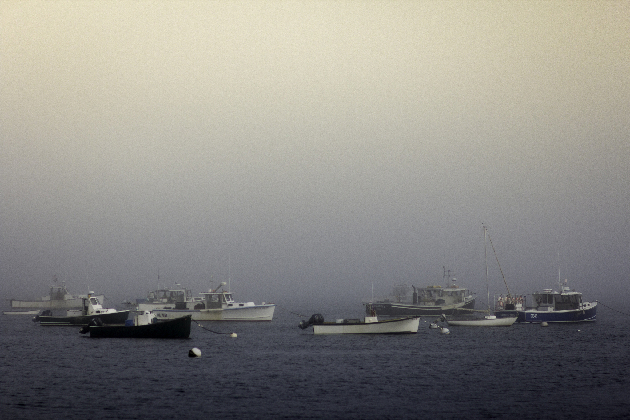 view of foggy camden harbour, maine, usa