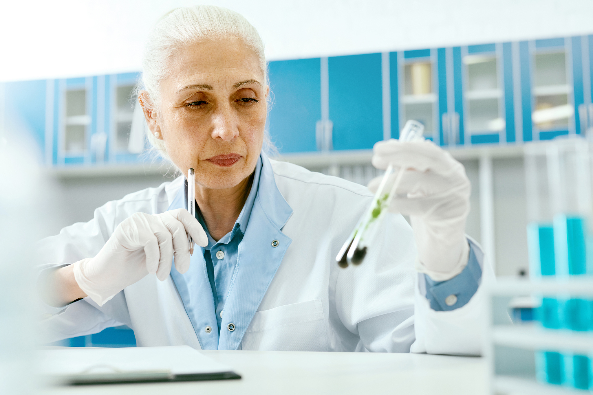 scientist with plant in scientific laboratory