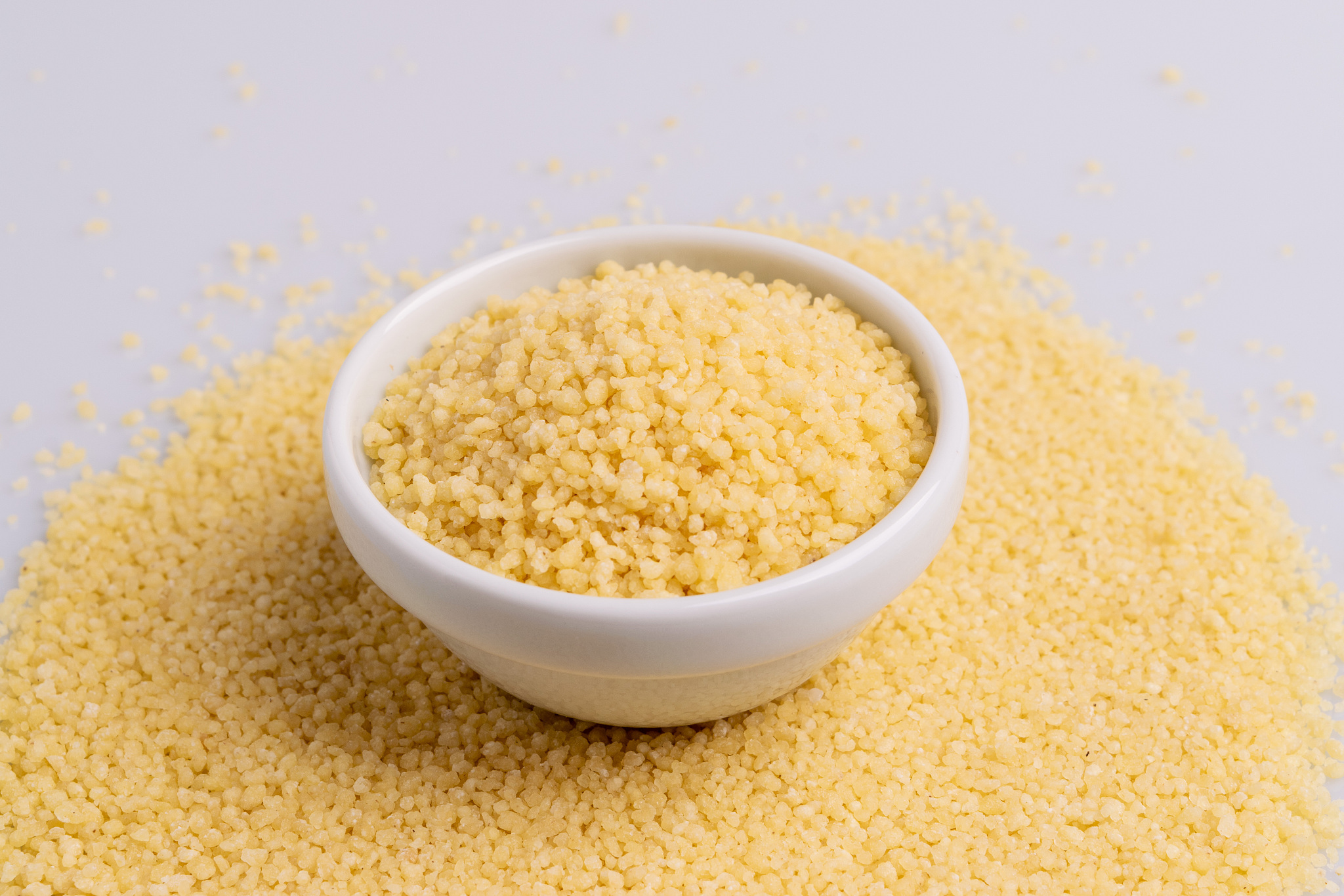 dry couscous isolated on white background, soft light, copy spac