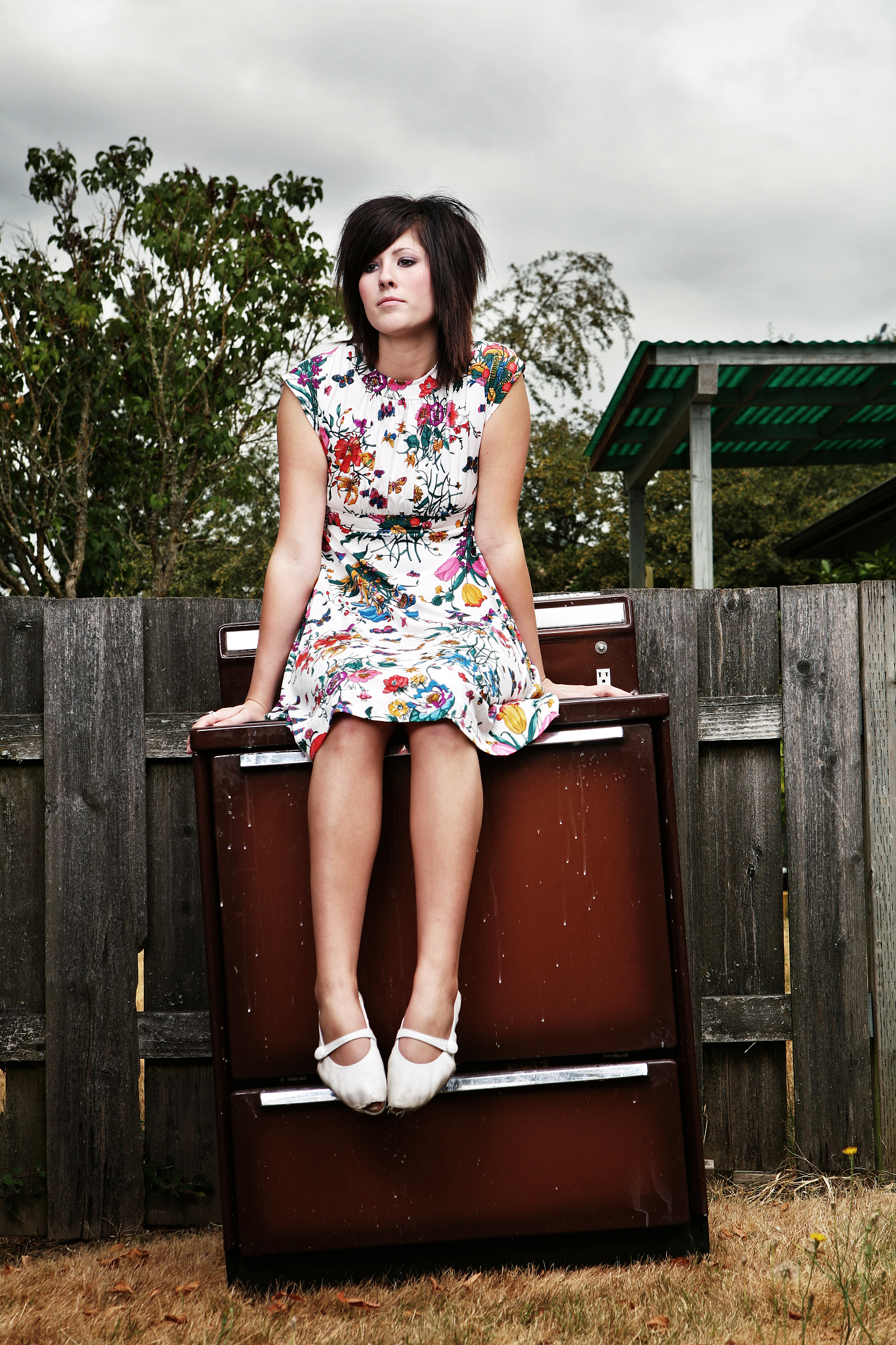 trendy brunette girl sitting on a stove