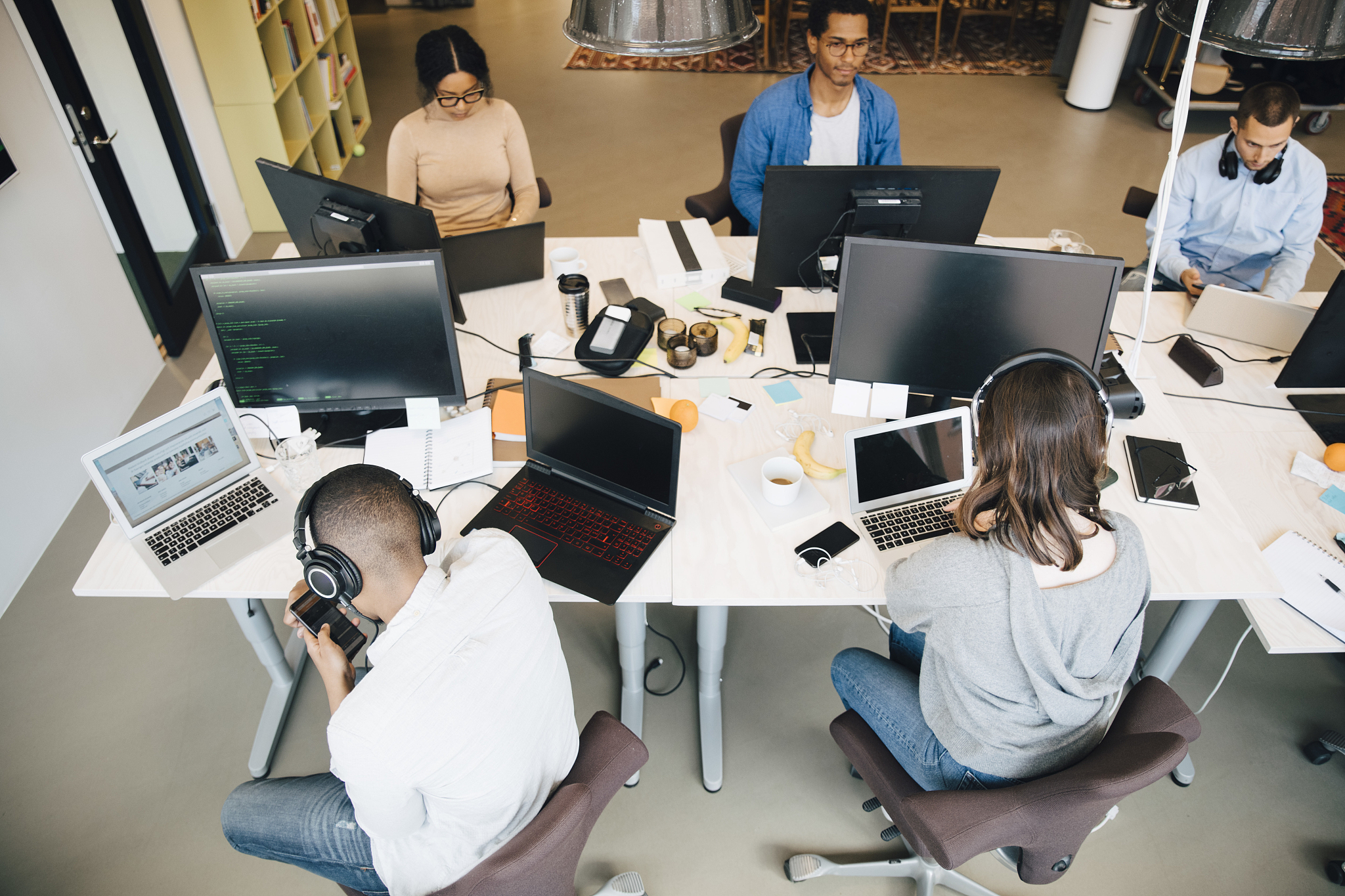 high angle view of it professionals using technology while sitti